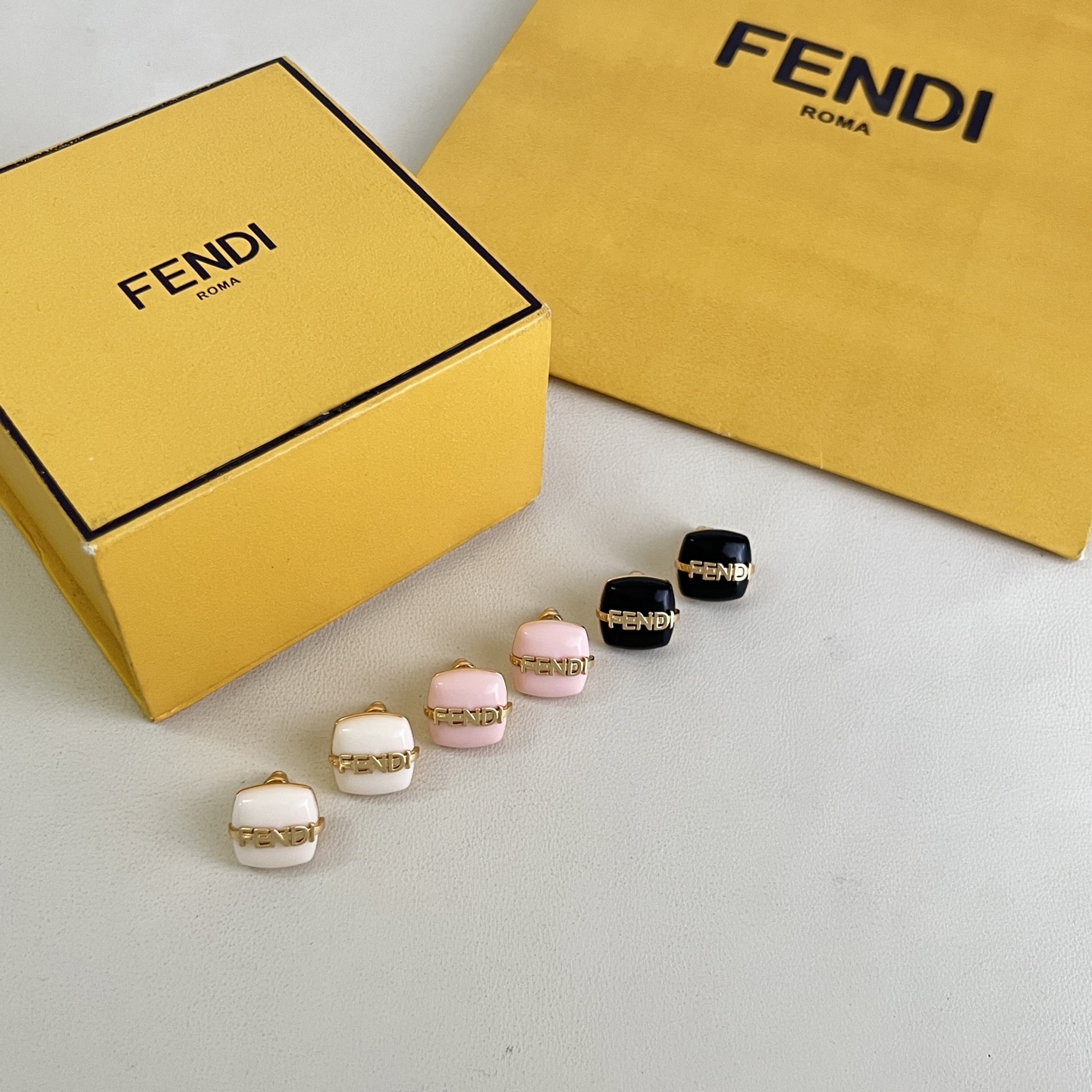 Fendi Fendi Logo Cushion Stud Earrings earrings Gold-tone metal with white pink or black resin accents 1cm stud diameter
