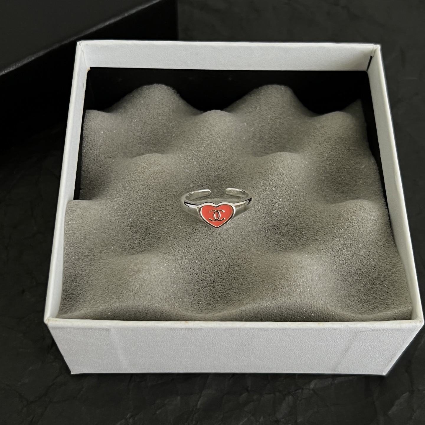 Chanel CC Heart Enamel Signet Ring ring silver-toned metal with coral red and black enamel heart accents featuring interlocking CC logo adjustable open band