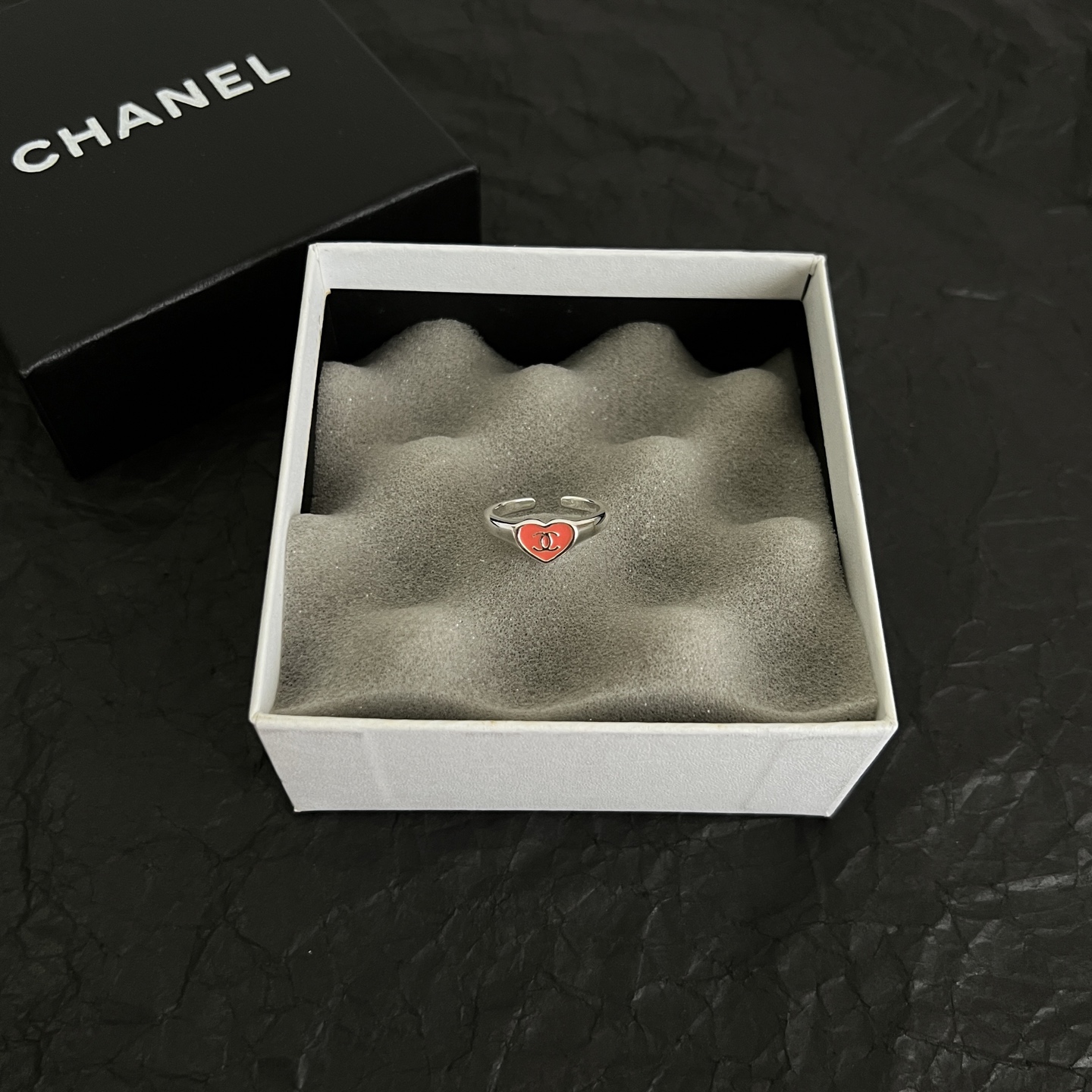 Chanel CC Heart Enamel Signet Ring ring silver-toned metal with coral red and black enamel heart accents featuring interlocking CC logo adjustable open band