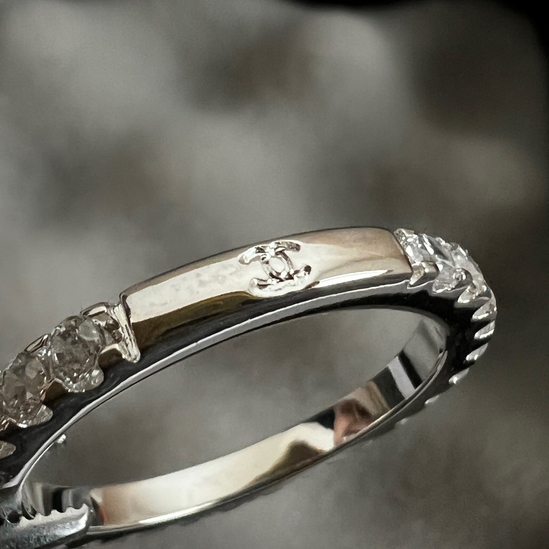 Chanel CC Logo Stackable Band Ring ring Silver-toned metal with clear faceted stones and black enamel accents US 7