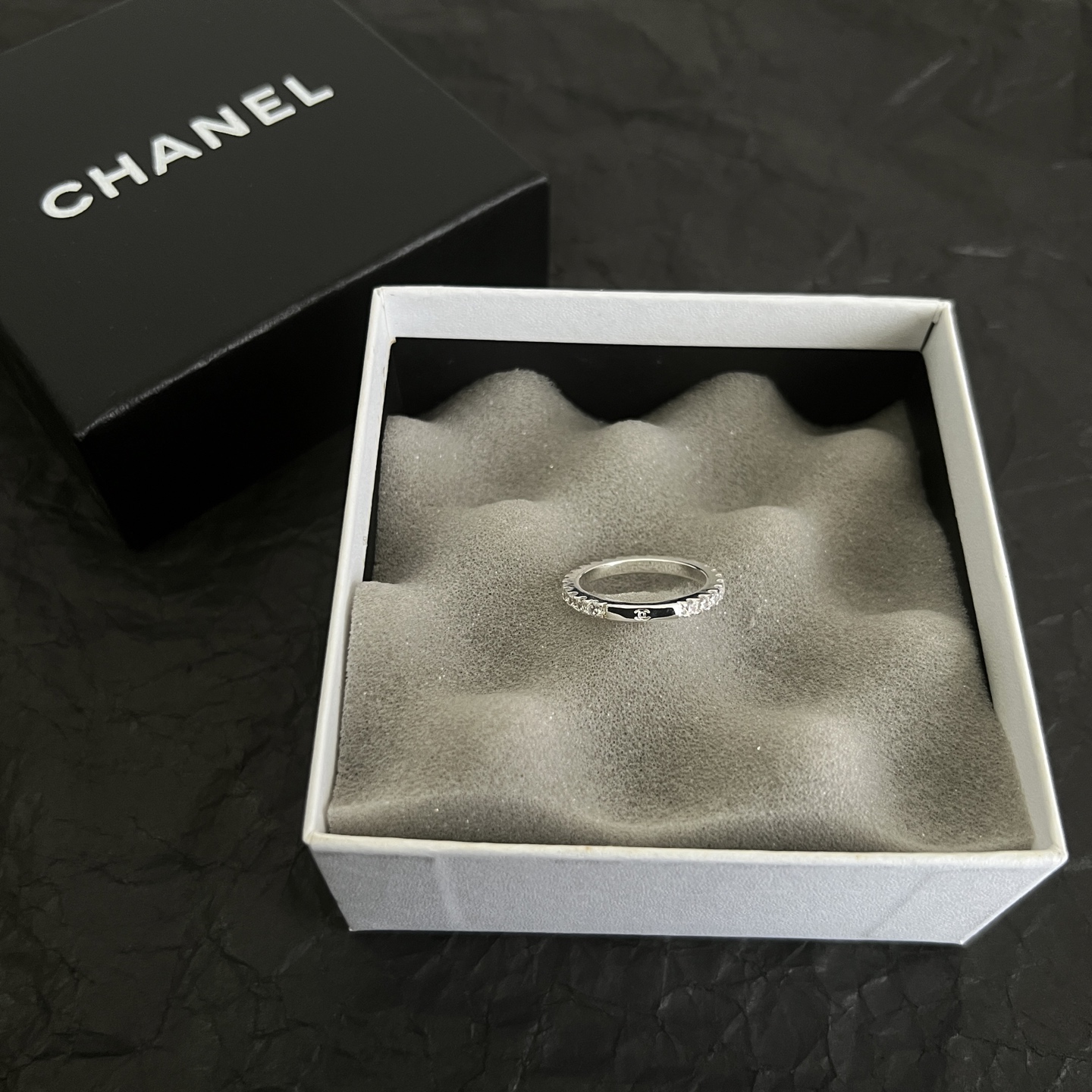Chanel CC Logo Stackable Band Ring ring Silver-toned metal with clear faceted stones and black enamel accents US 7