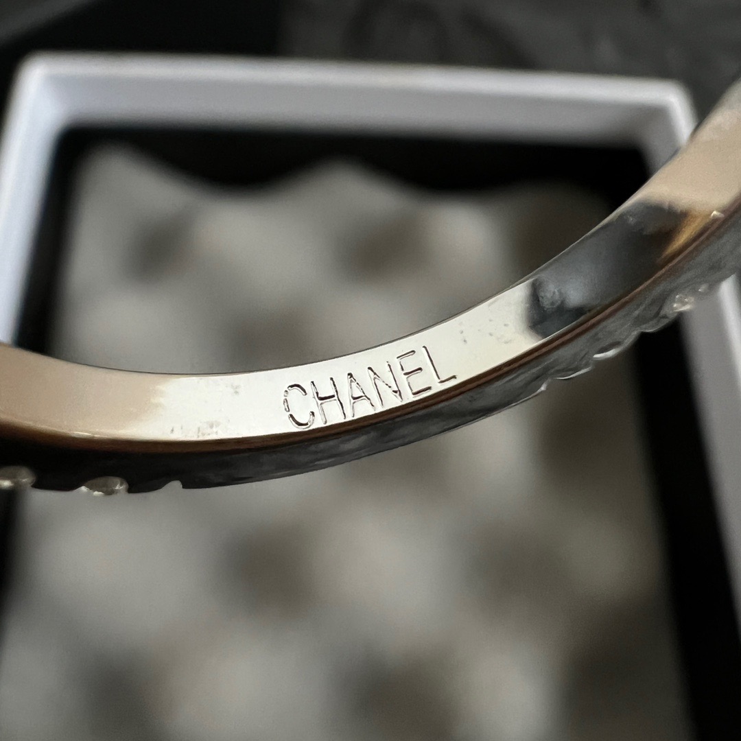 Chanel CC Logo Stackable Band Ring ring Silver-toned metal with clear faceted stones and black enamel accents US 7