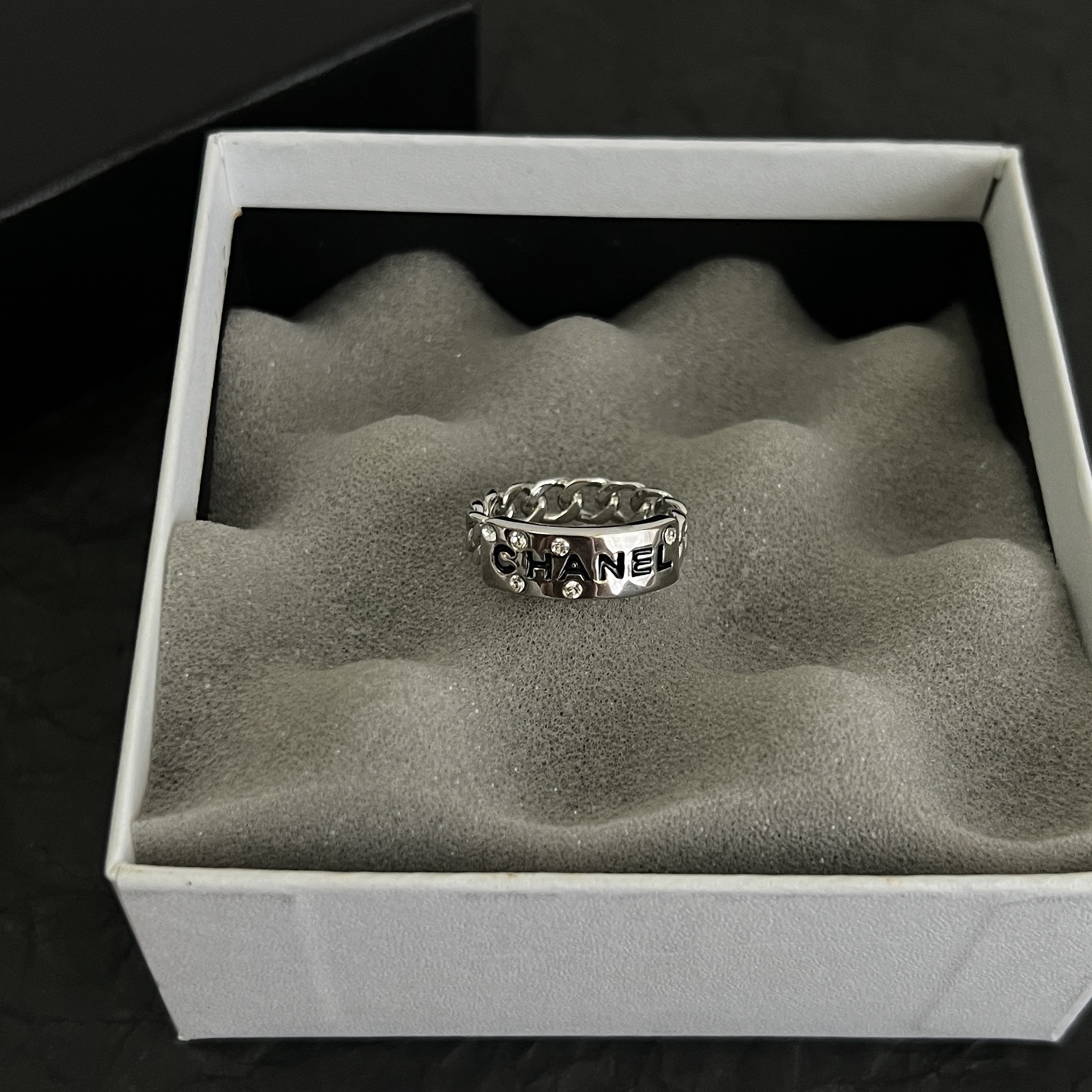 Chanel Logo Chain Crystal Ring ring Silver-toned metal with clear crystal accents and black enamel lettering US 7
