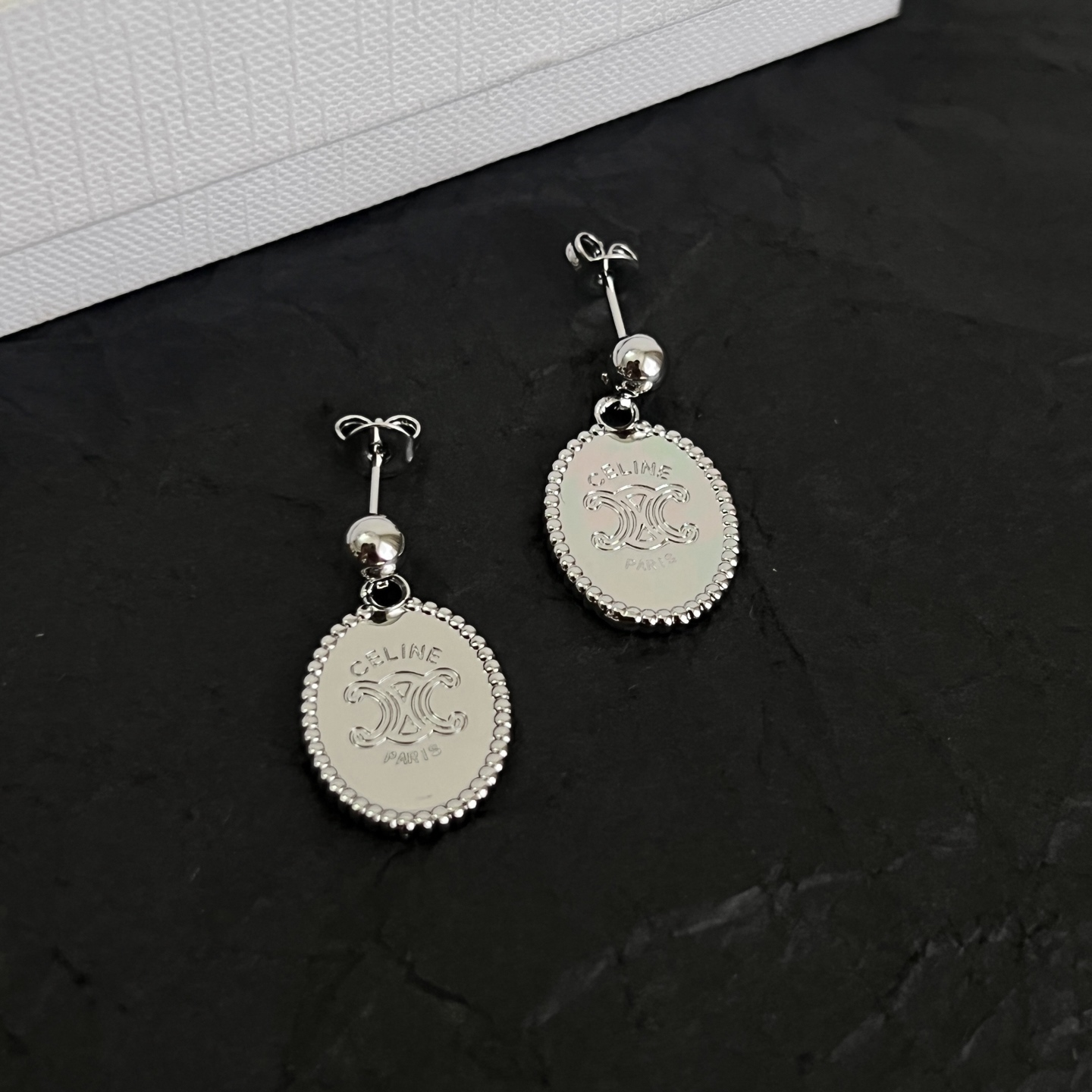 Celine Triomphe Oval Medallion Drop Earrings earrings Available in polished silver-tone metal and polished gold-tone metal with engraved Triomphe logo detailing One Size standard post drop length