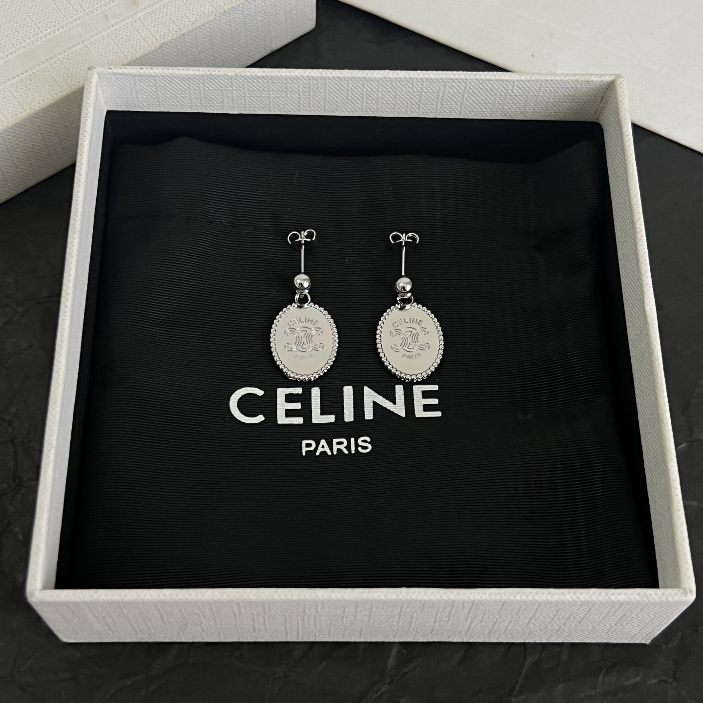 Celine Triomphe Oval Medallion Drop Earrings earrings Available in polished silver-tone metal and polished gold-tone metal with engraved Triomphe logo detailing One Size standard post drop length