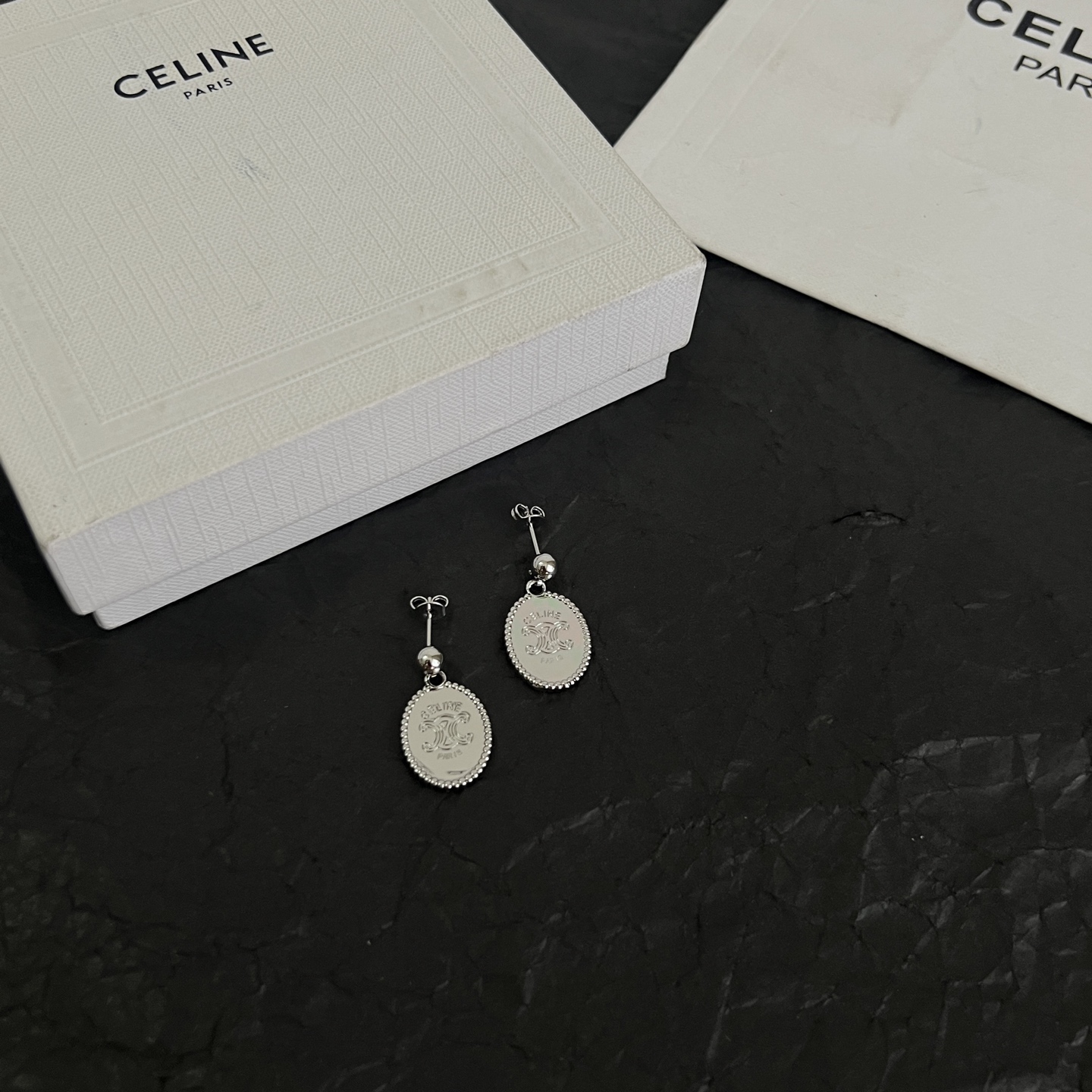 Celine Triomphe Oval Medallion Drop Earrings earrings Available in polished silver-tone metal and polished gold-tone metal with engraved Triomphe logo detailing One Size standard post drop length