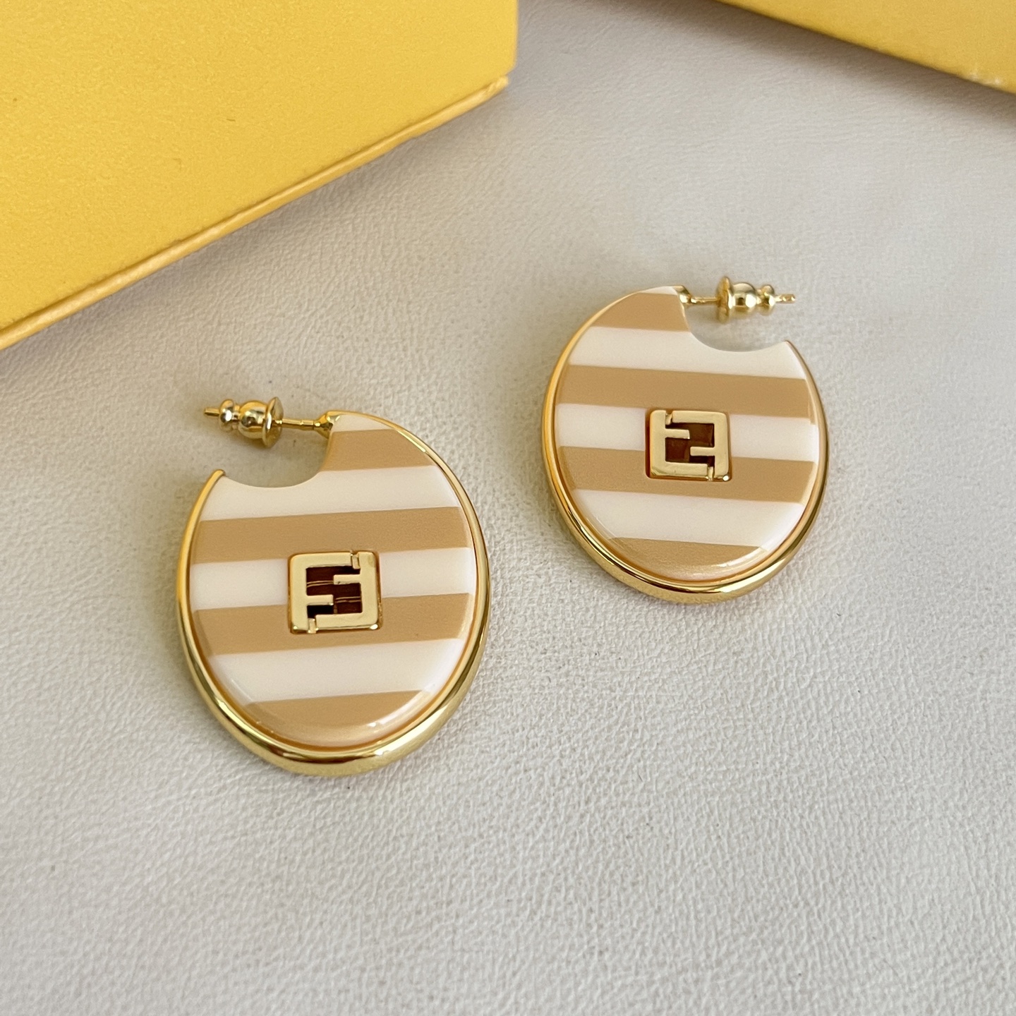 Fendi FF Logo Striped Hoop Earrings earrings Gold-tone metal with beige and white striped enamel gold FF logo accents One Size