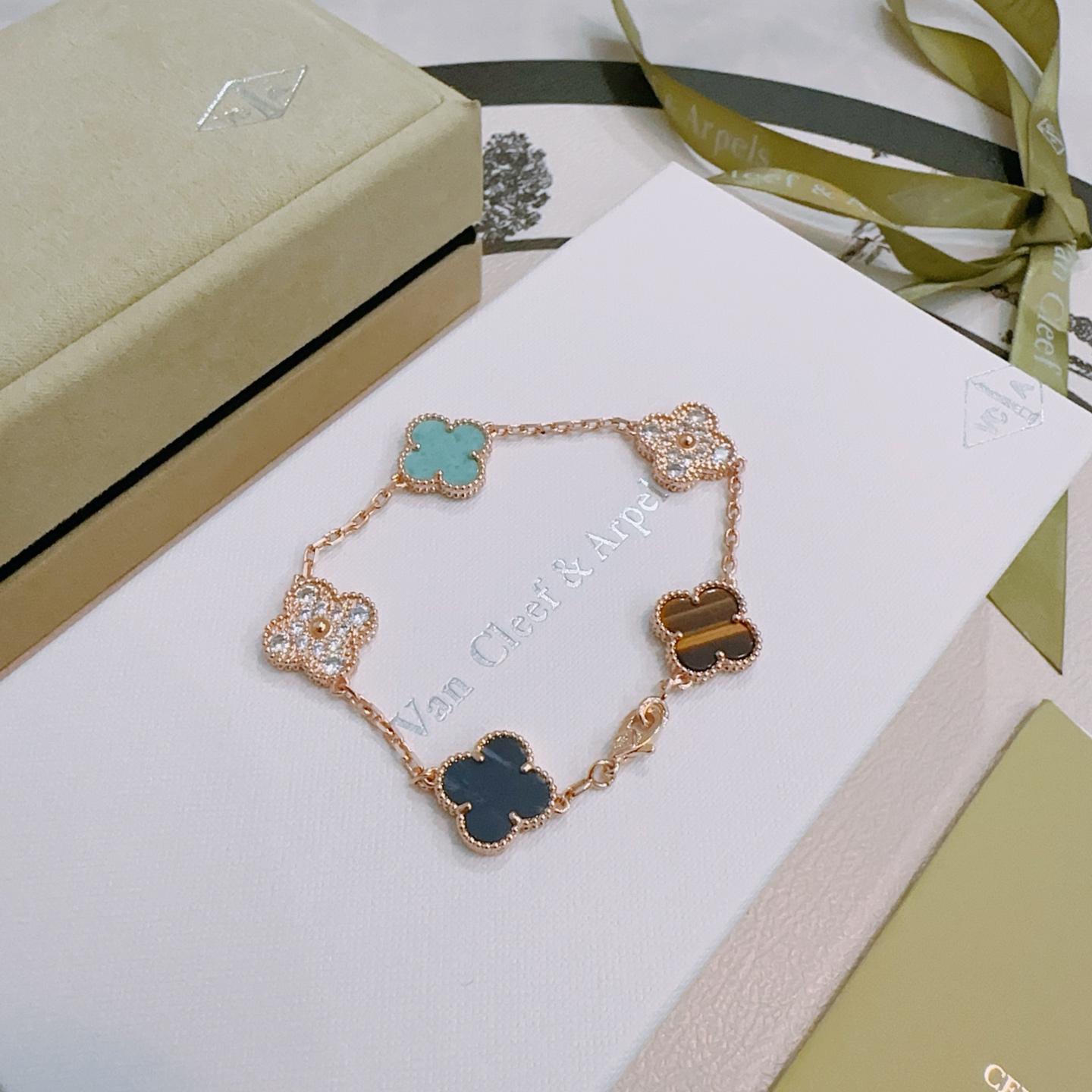 Van Cleef Arpels Alhambra bracelet Rose gold metal with turquoise dark blue stone tiger s eye and clear diamond accents 17cm