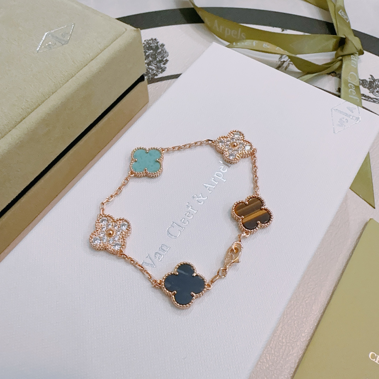 Van Cleef Arpels Alhambra bracelet Rose gold metal with turquoise dark blue stone tiger s eye and clear diamond accents 17cm