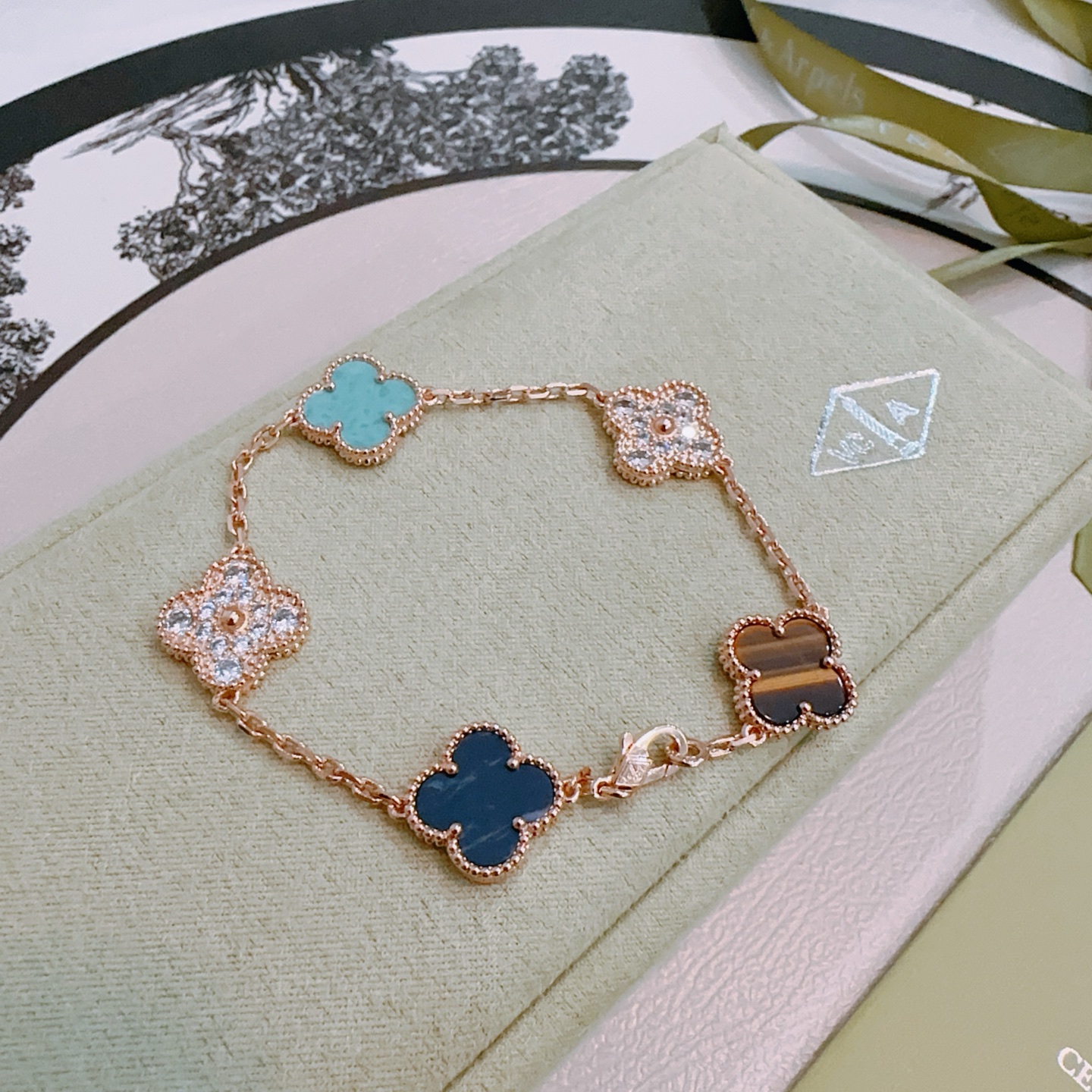 Van Cleef Arpels Alhambra bracelet Rose gold metal with turquoise dark blue stone tiger s eye and clear diamond accents 17cm
