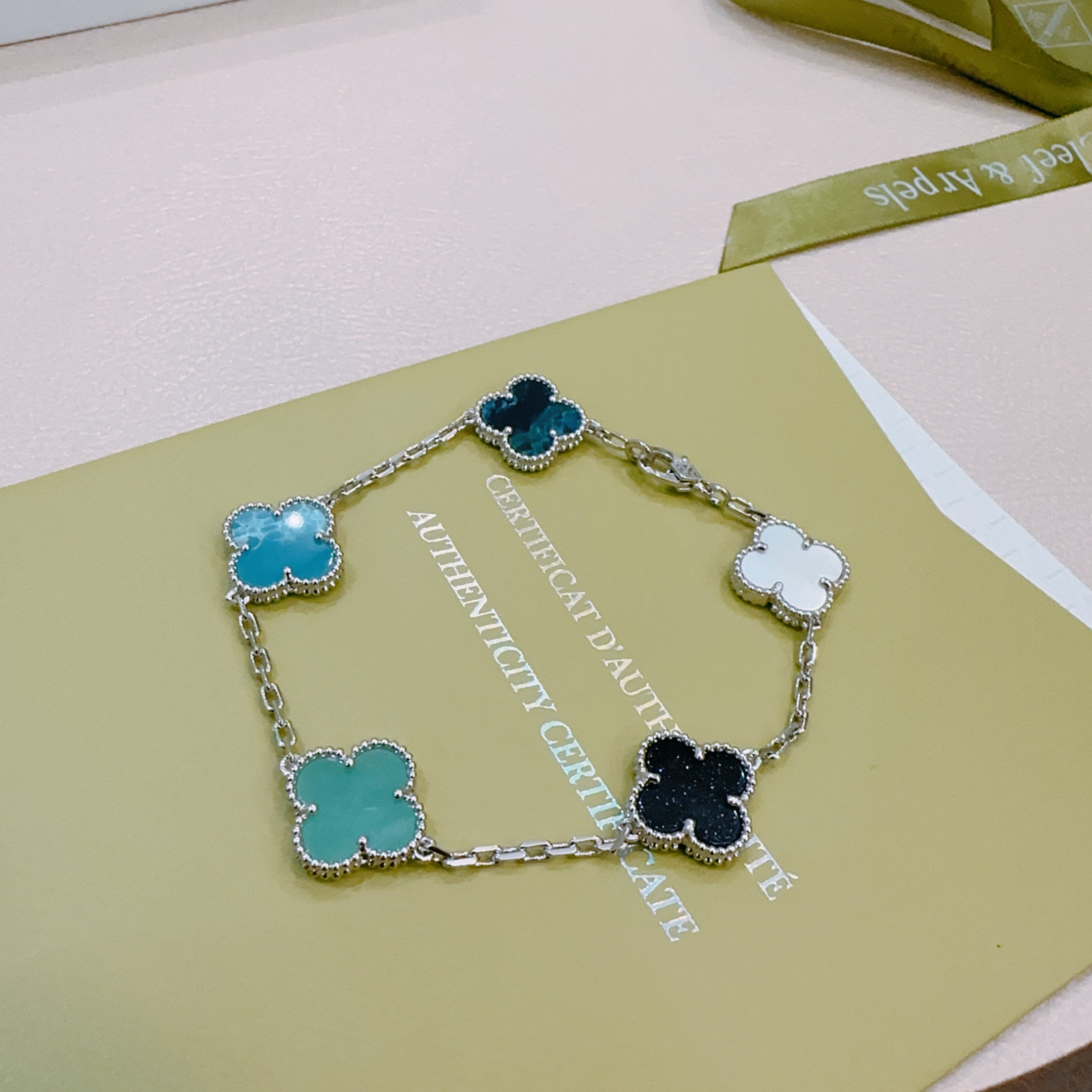 Van Cleef Arpels Alhambra bracelet Silver-toned metal with white mother-of-pearl black onyx turquoise blue agate and dark teal chalcedony clover motifs 17cm