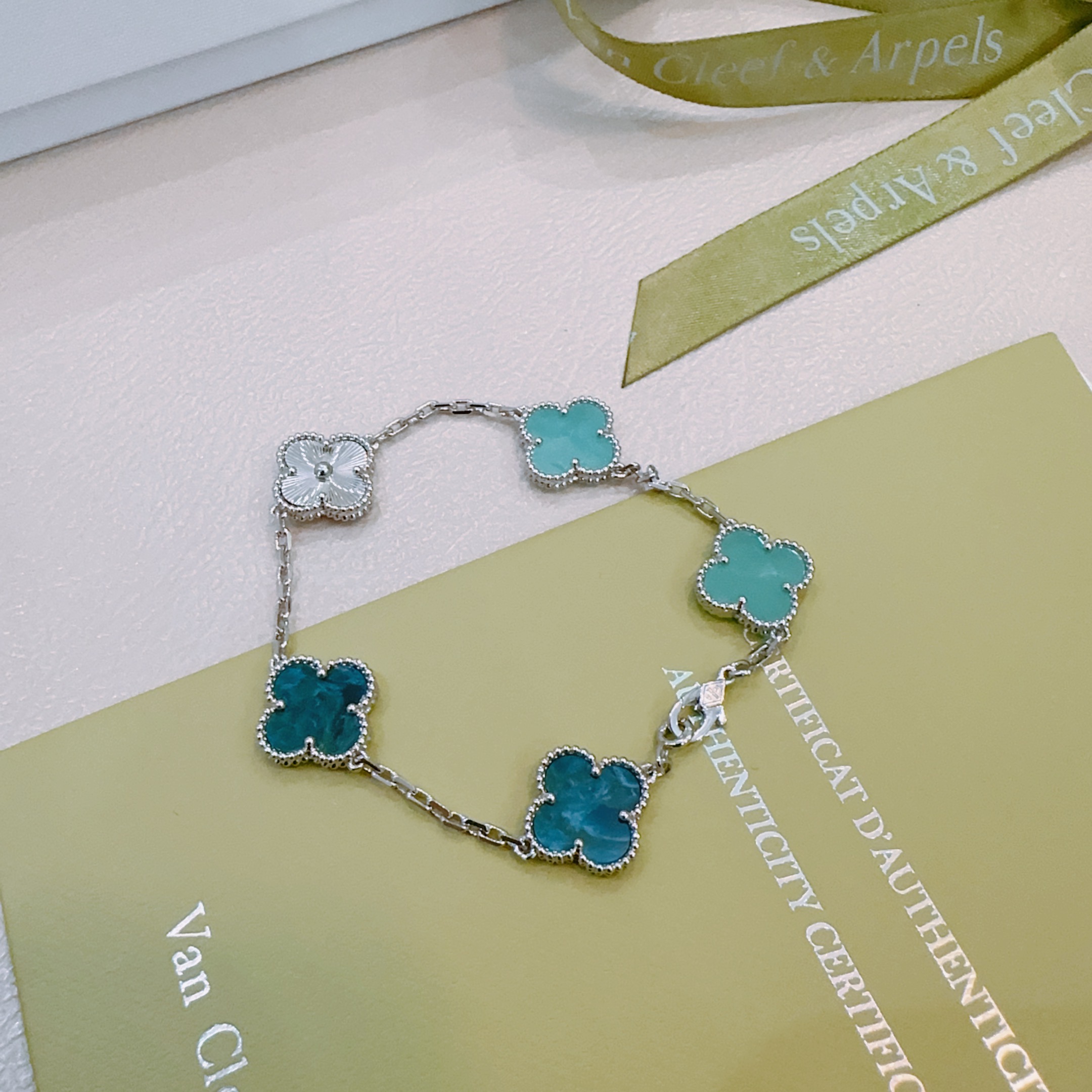 Van Cleef Arpels Alhambra bracelet silver-toned metal with turquoise blue teal blue and silver guilloche four-leaf clover motifs 17cm