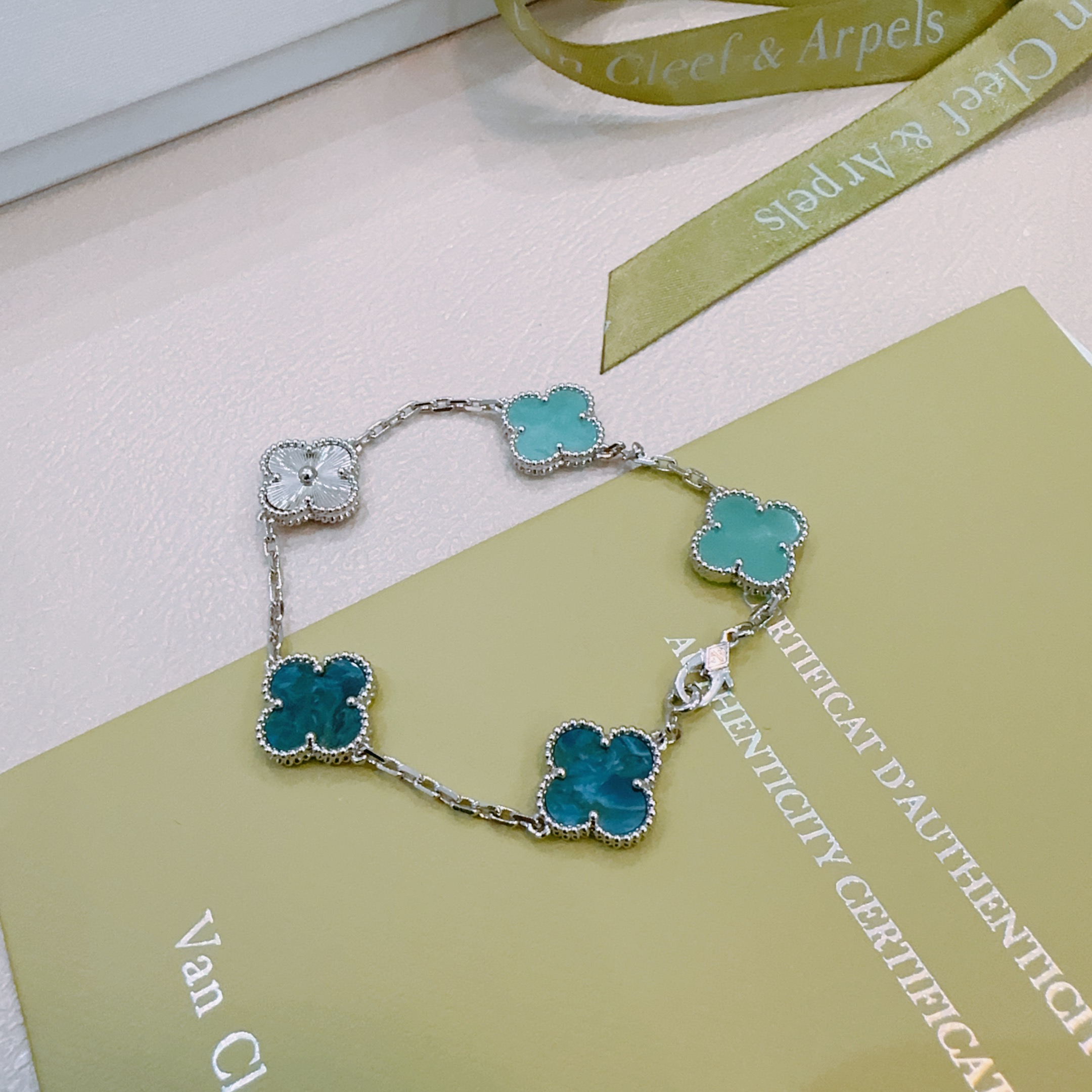 Van Cleef Arpels Alhambra bracelet silver-toned metal with turquoise blue teal blue and silver guilloche four-leaf clover motifs 17cm