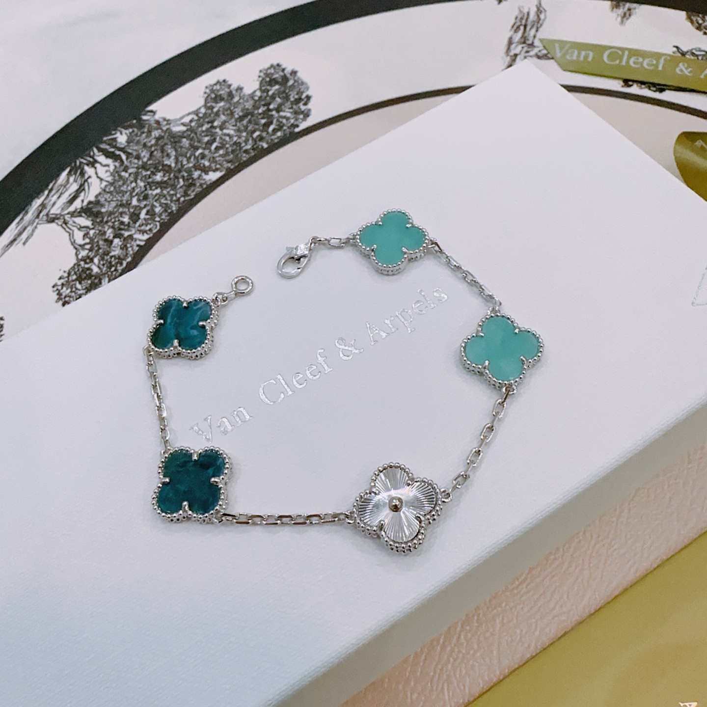 Van Cleef Arpels Alhambra bracelet silver-toned metal with turquoise blue teal blue and silver guilloche four-leaf clover motifs 17cm
