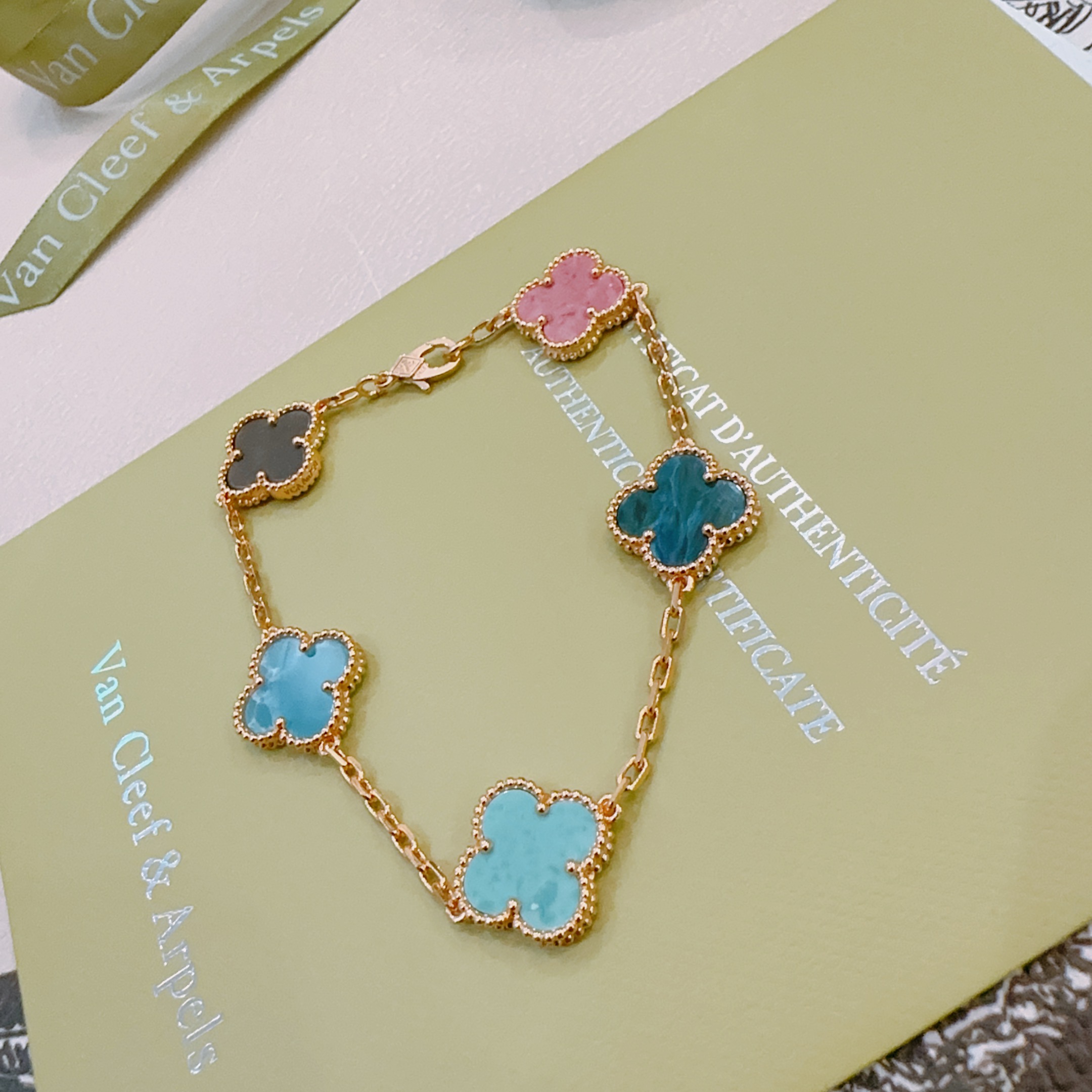 Van Cleef Arpels Vintage Alhambra bracelet Rose gold metal with multicolor clover stones including dark gray pink light sky blue teal blue and turquoise 18cm