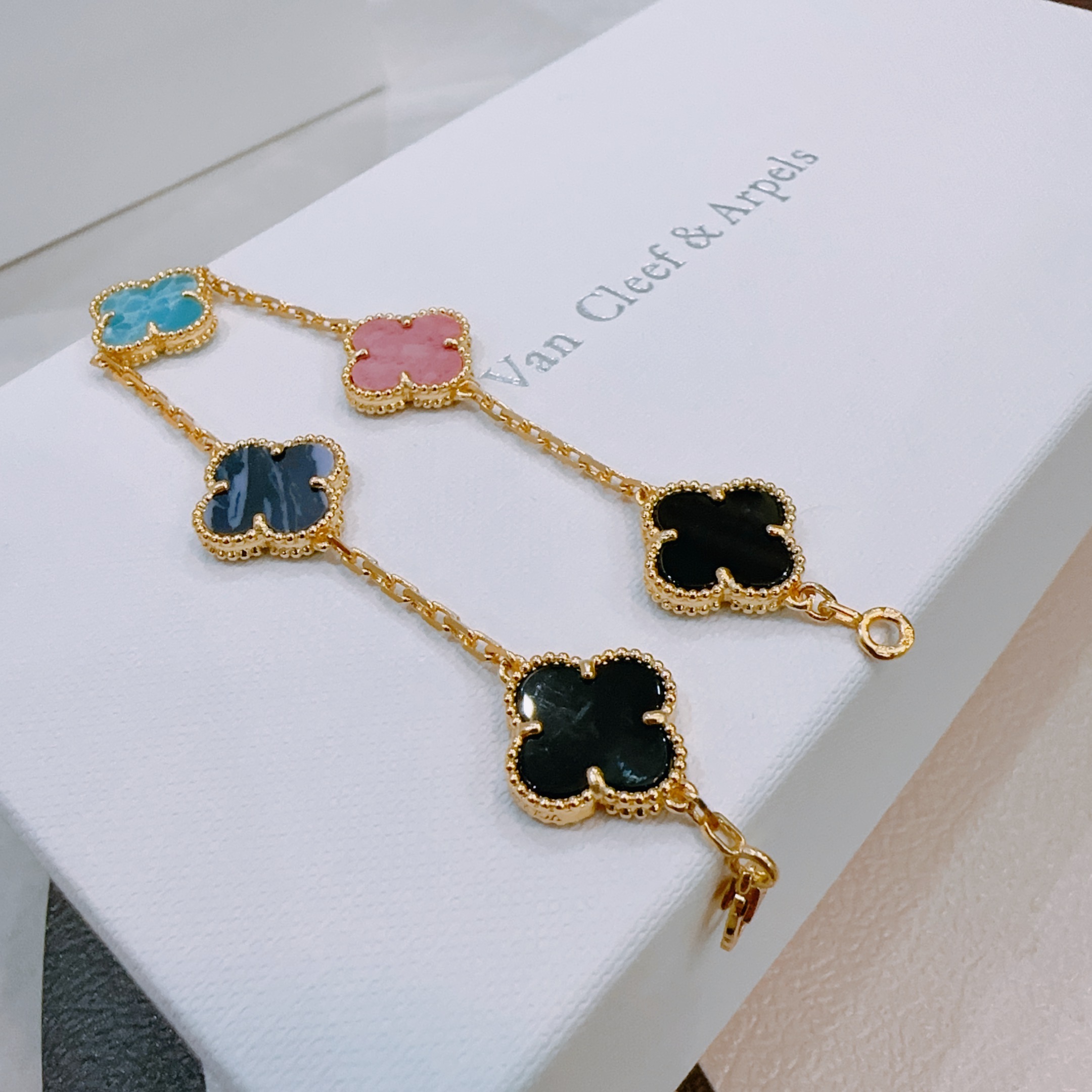 Van Cleef Arpels Alhambra bracelet Gold-toned metal with turquoise blue dark blue pink and black clover inlays 19cm