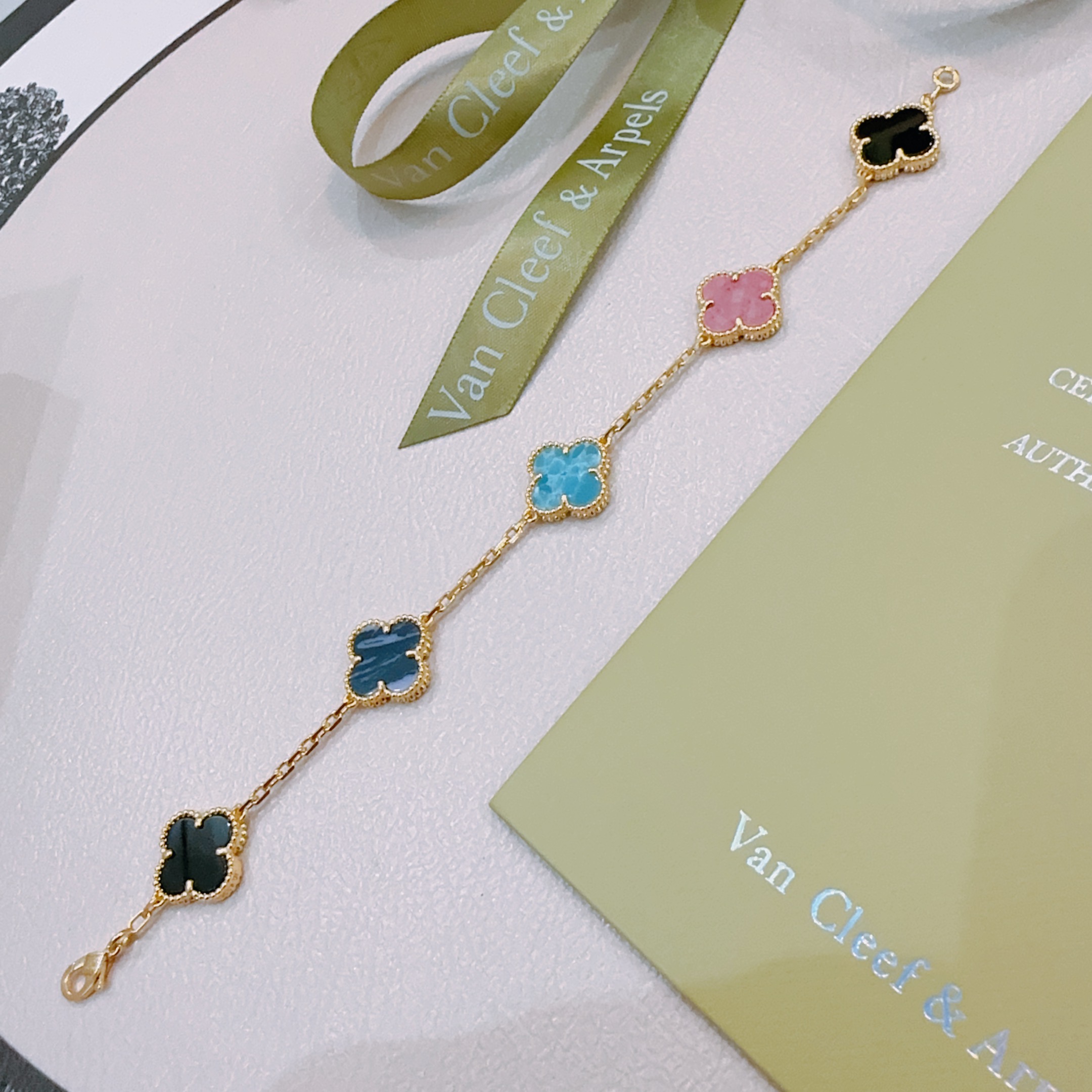 Van Cleef Arpels Alhambra bracelet Gold-toned metal with turquoise blue dark blue pink and black clover inlays 19cm