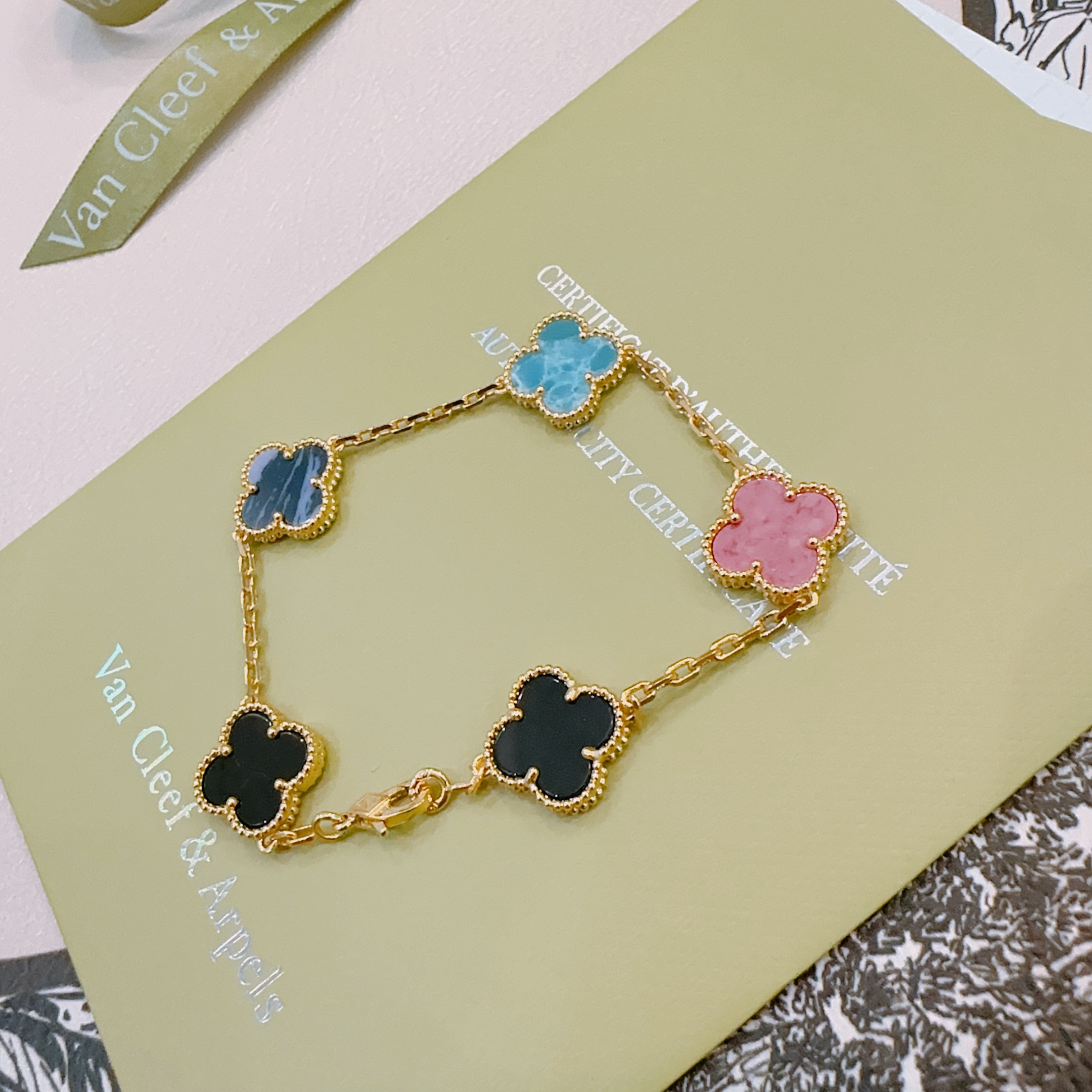 Van Cleef Arpels Alhambra bracelet Gold-toned metal with turquoise blue dark blue pink and black clover inlays 19cm