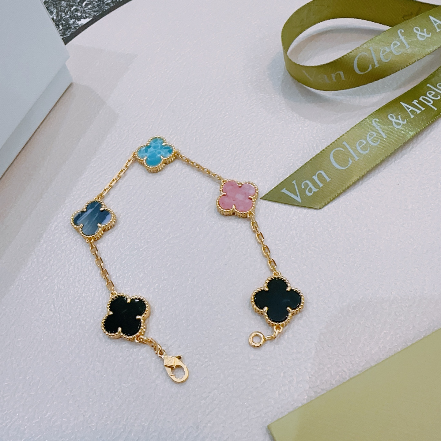 Van Cleef Arpels Alhambra bracelet Gold-toned metal with turquoise blue dark blue pink and black clover inlays 19cm