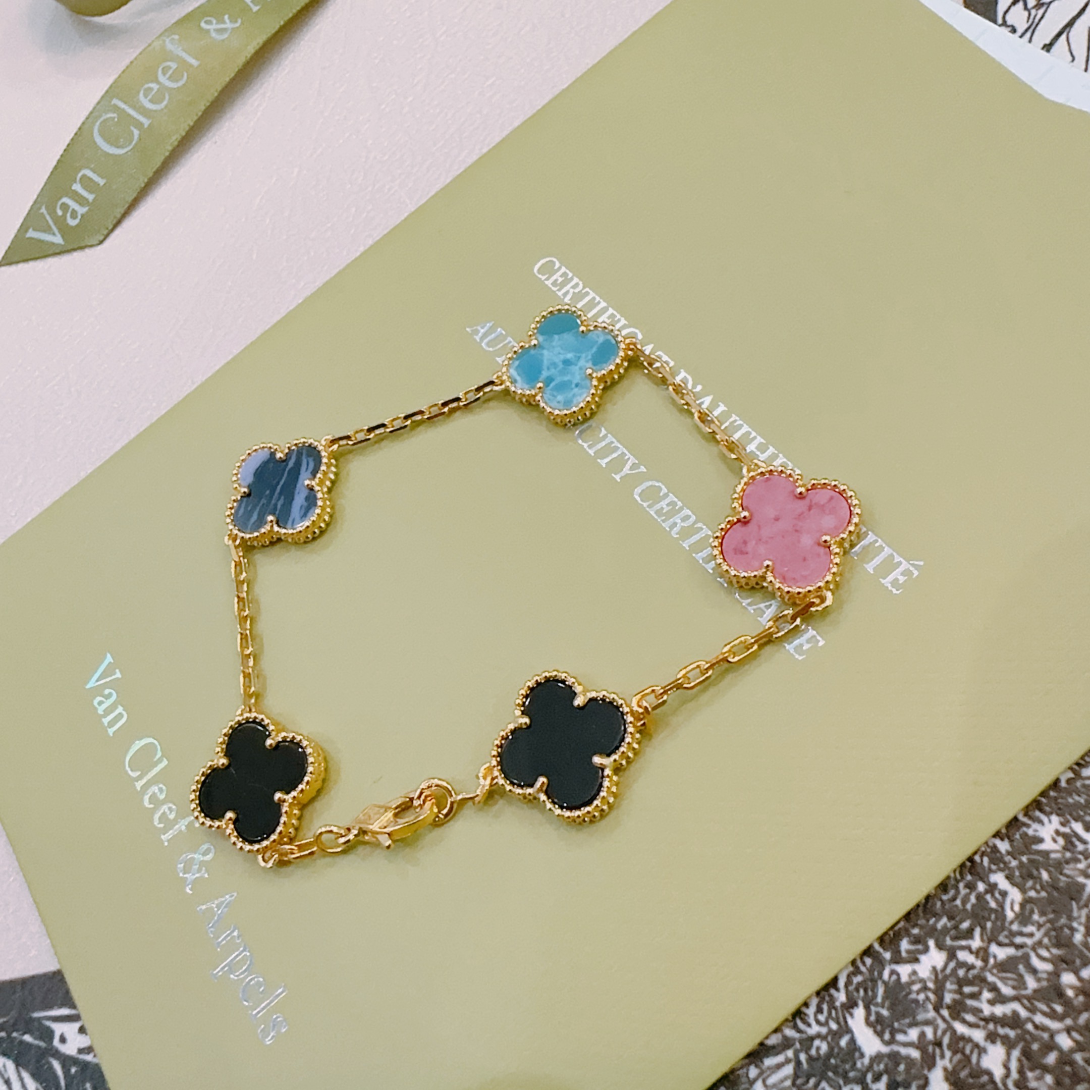 Van Cleef Arpels Alhambra bracelet Gold-toned metal with turquoise blue dark blue pink and black clover inlays 19cm