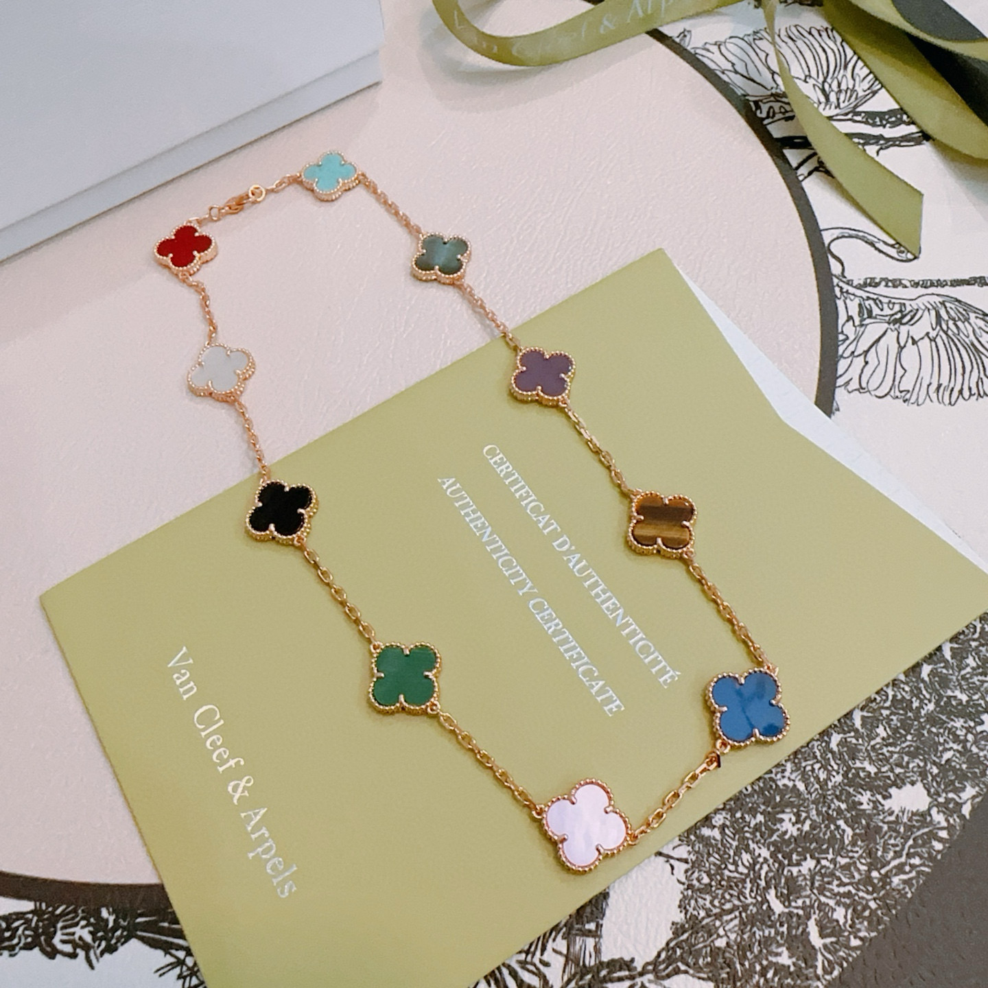 Van Cleef Arpels Alhambra necklace rose gold with multicolor clover inlays red turquoise gray-green purple tiger s eye brown blue light pink mother-of-pearl green malachite black onyx white mother-of-pearl 42cm