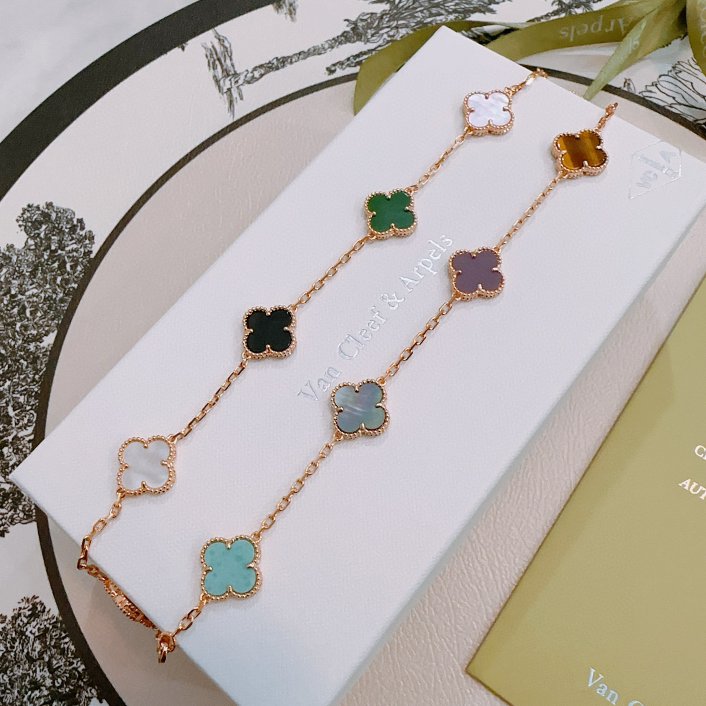 Van Cleef Arpels Alhambra necklace rose gold with multicolor clover inlays red turquoise gray-green purple tiger s eye brown blue light pink mother-of-pearl green malachite black onyx white mother-of-pearl 42cm