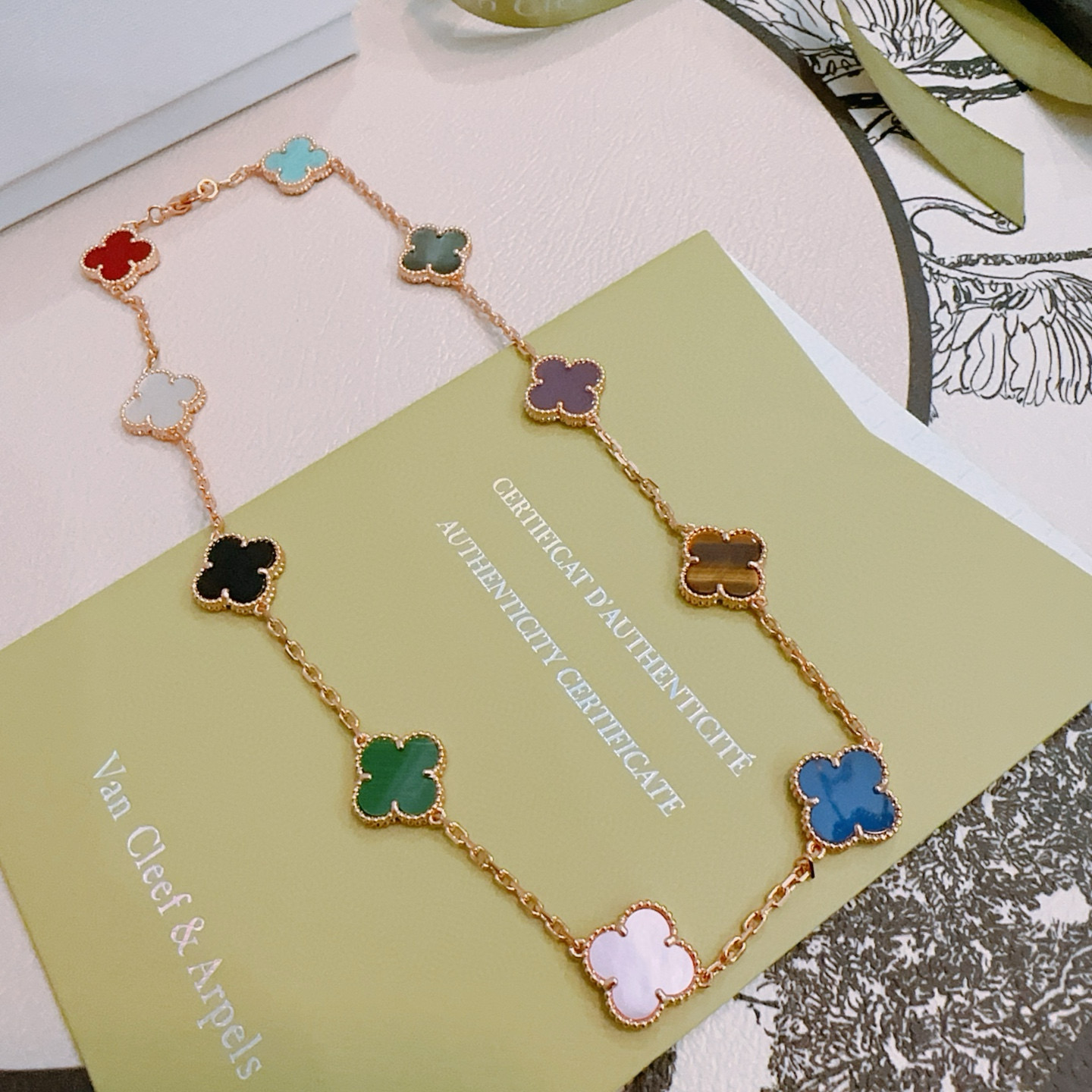 Van Cleef Arpels Alhambra necklace rose gold with multicolor clover inlays red turquoise gray-green purple tiger s eye brown blue light pink mother-of-pearl green malachite black onyx white mother-of-pearl 42cm