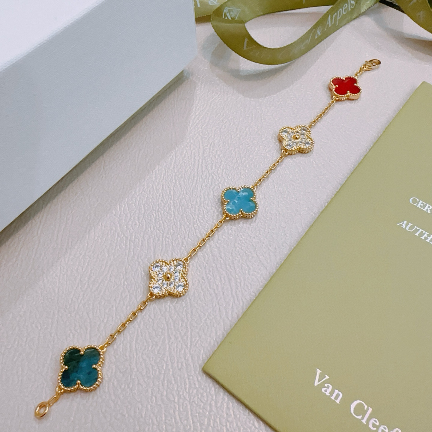 Van Cleef Arpels Alhambra bracelet Gold metal with red turquoise blue teal blue and clear diamond-accented four-leaf clover motifs 17cm