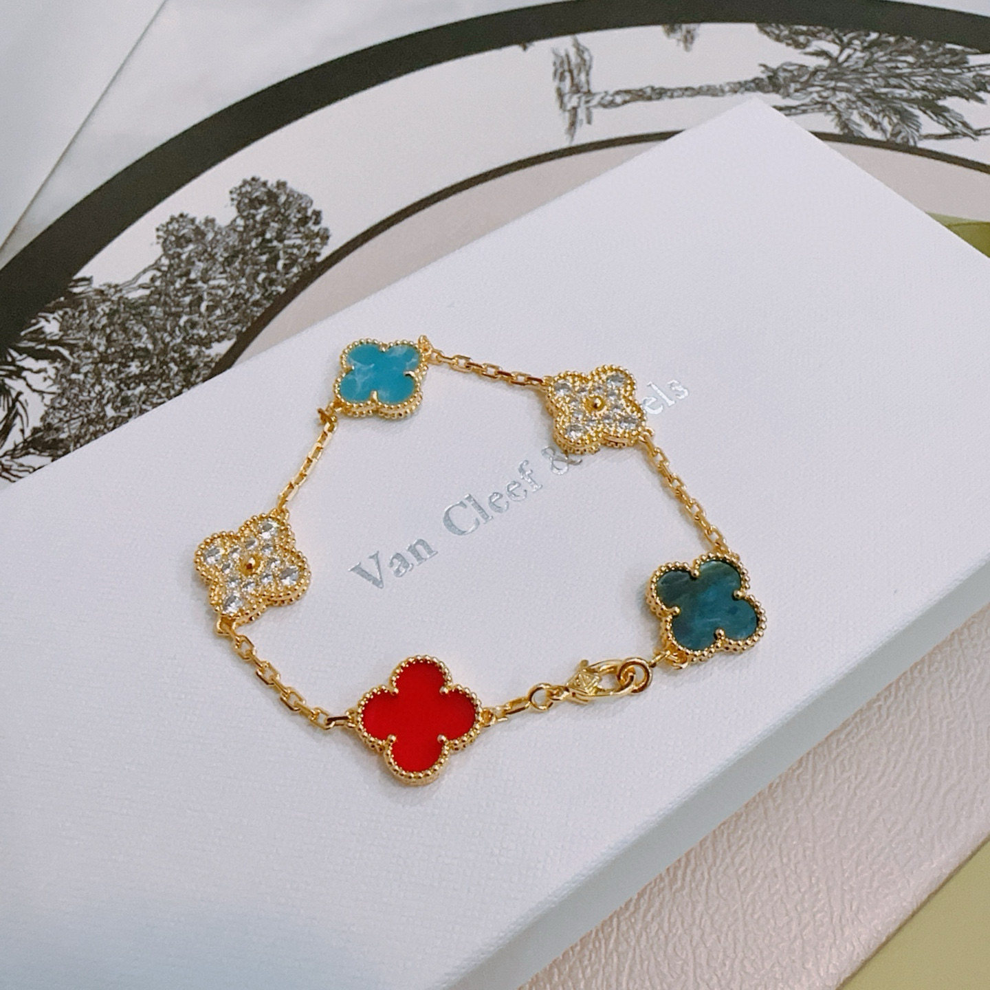 Van Cleef Arpels Alhambra bracelet Gold metal with red turquoise blue teal blue and clear diamond-accented four-leaf clover motifs 17cm