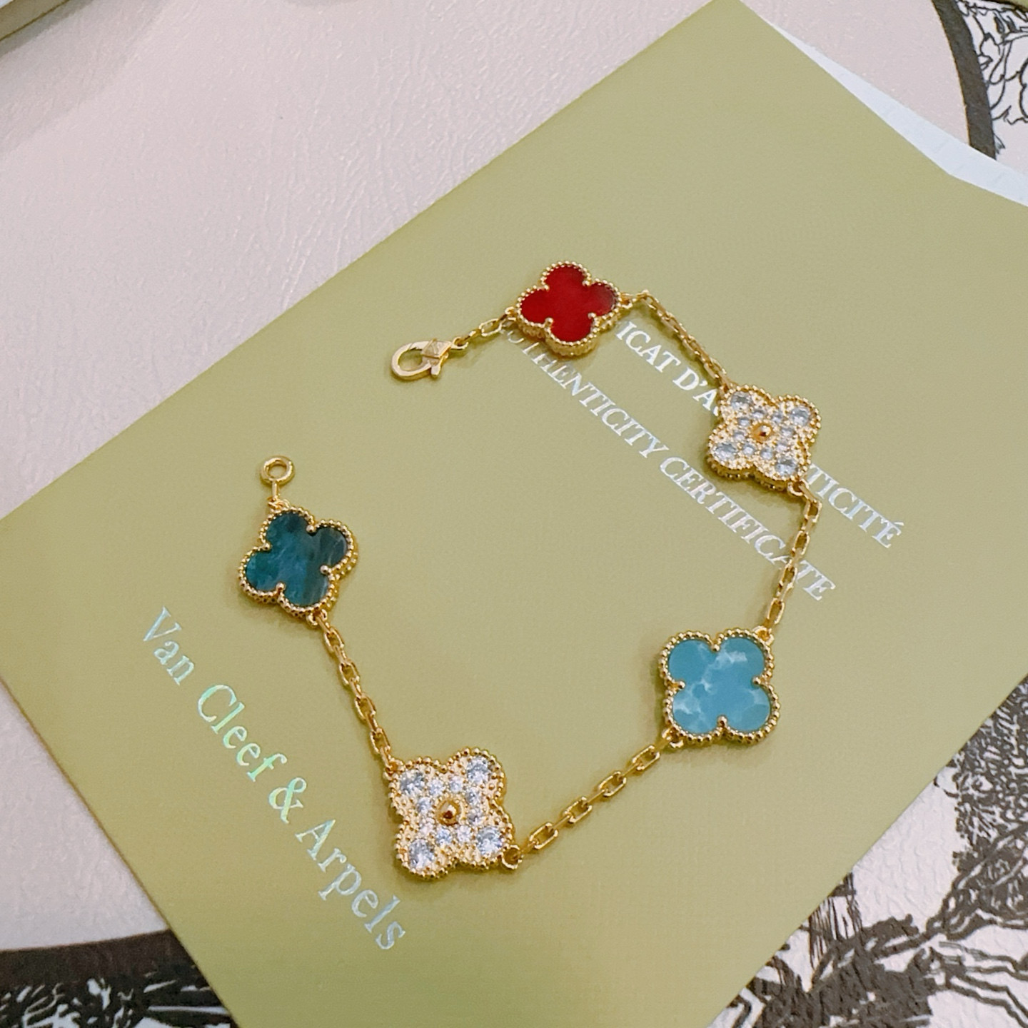 Van Cleef Arpels Alhambra bracelet Gold metal with red turquoise blue teal blue and clear diamond-accented four-leaf clover motifs 17cm
