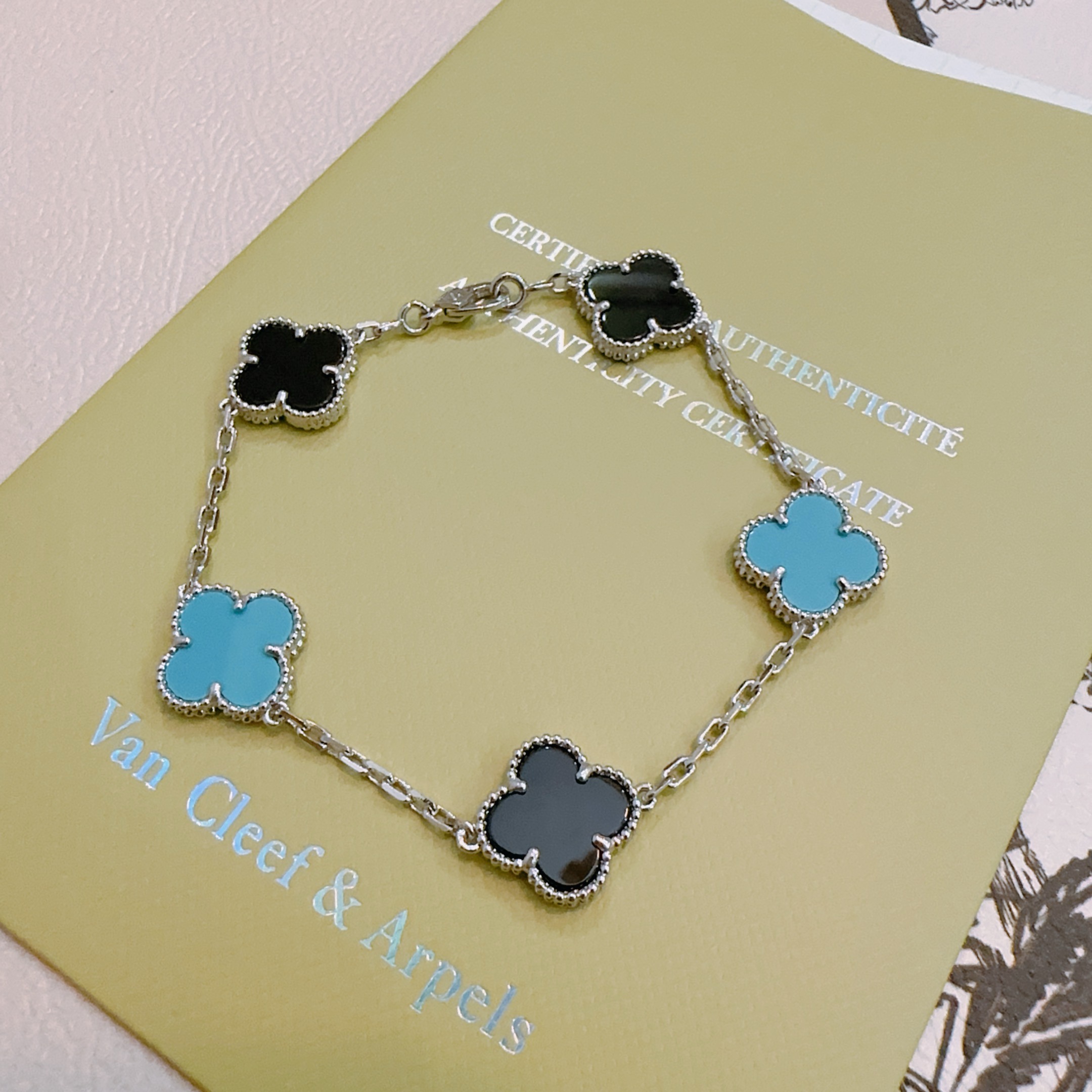 Van Cleef Arpels Alhambra bracelet silver-toned metal with black onyx and turquoise blue clover inlays 17cm