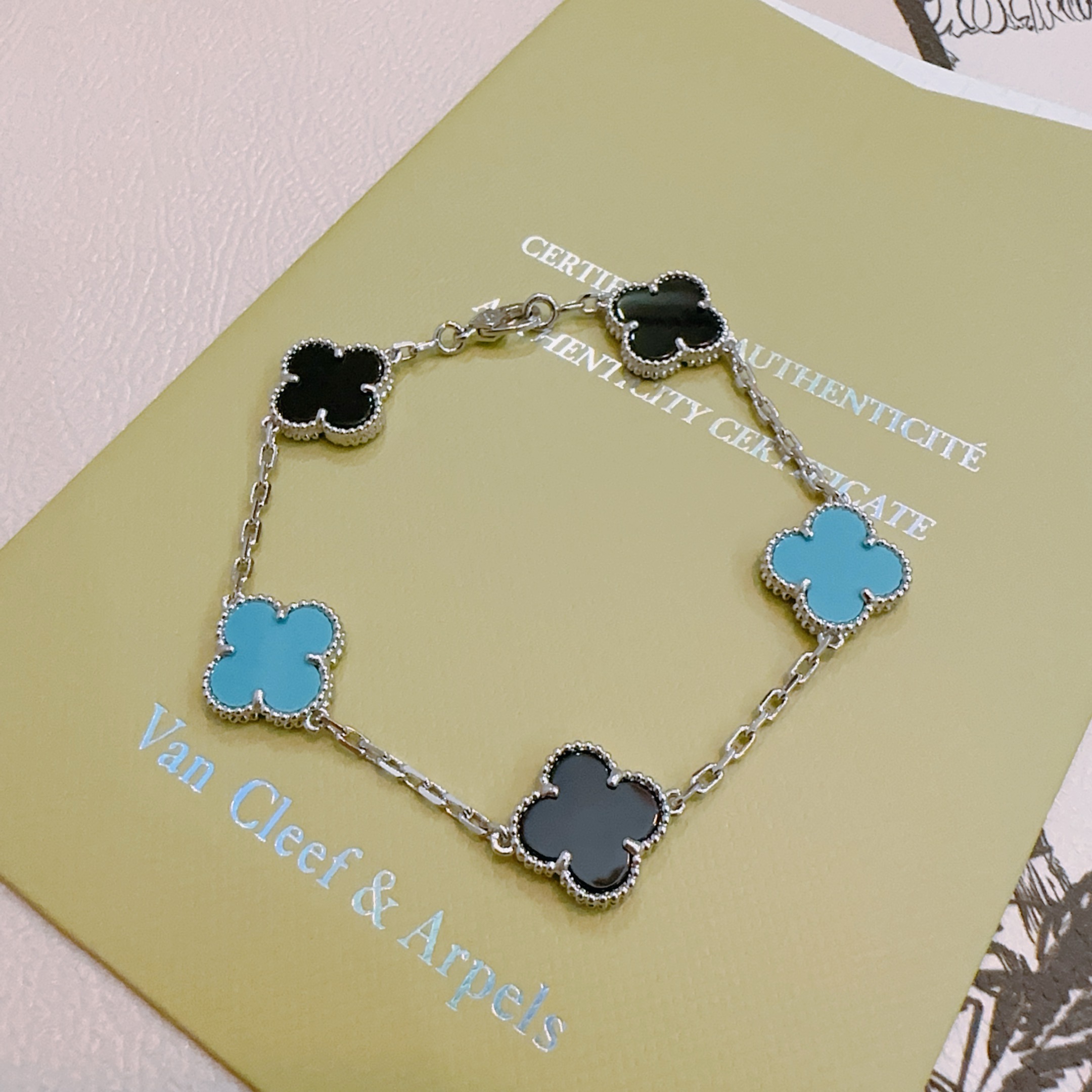 Van Cleef Arpels Alhambra bracelet silver-toned metal with black onyx and turquoise blue clover inlays 17cm