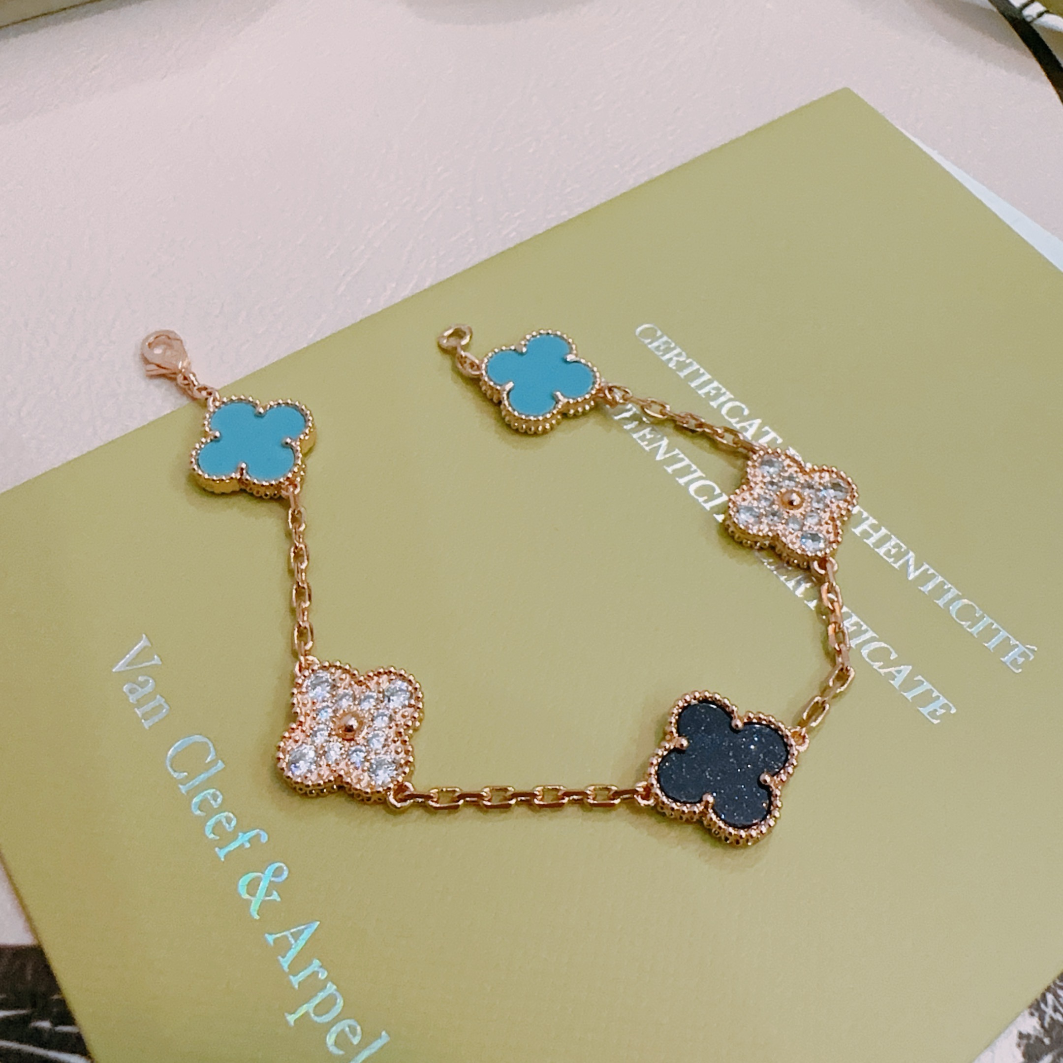 Van Cleef Arpels Alhambra bracelet Rose gold metal with turquoise blue black and clear diamond-accented four-leaf clover motifs 18cm