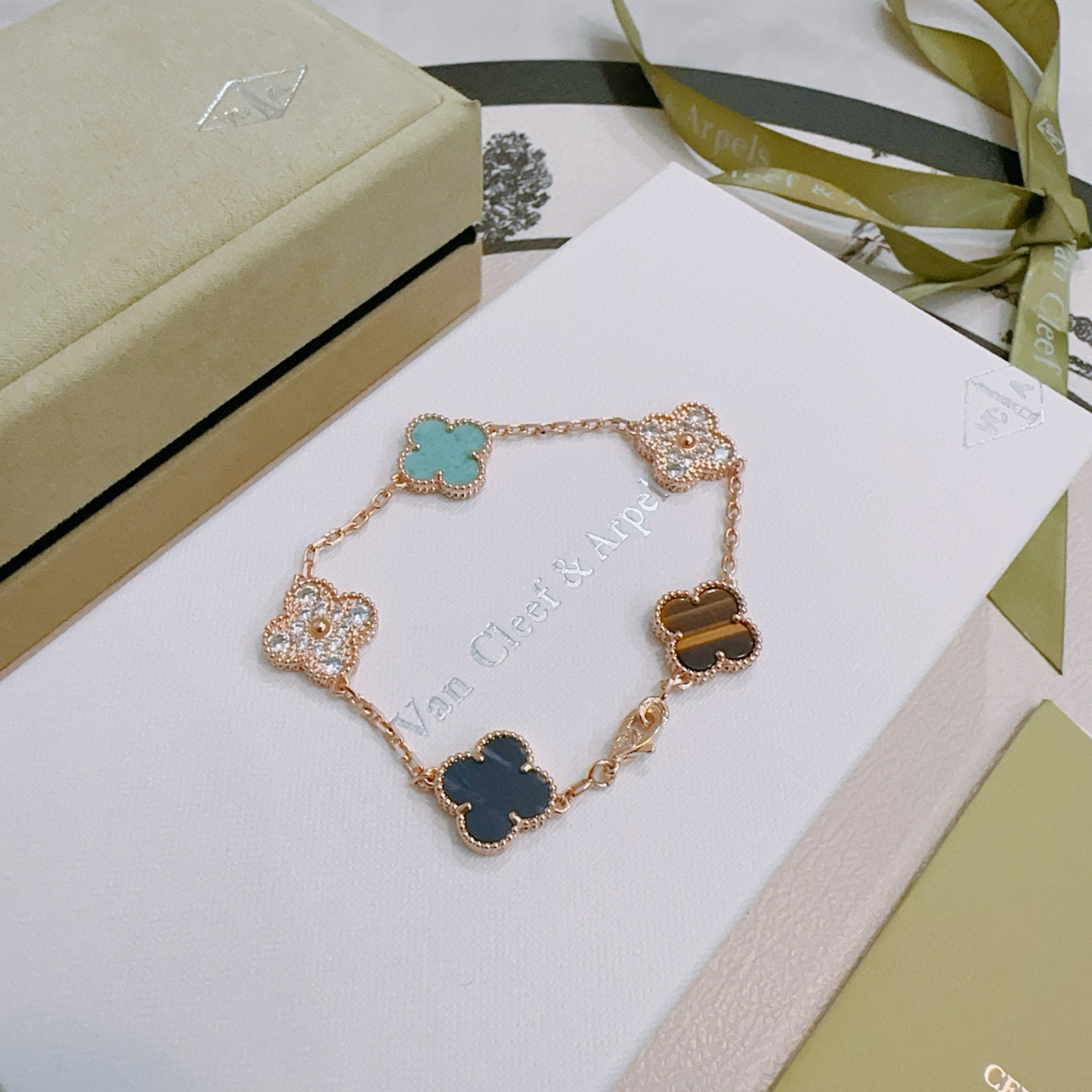 Van Cleef Arpels Alhambra bracelet Rose gold with turquoise dark blue stone tiger s eye and clear diamond accents 18cm