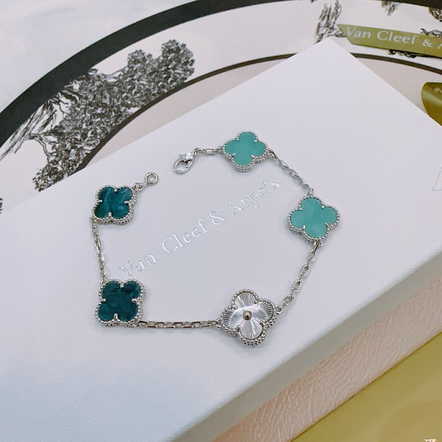Van Cleef Arpels Alhambra bracelet Silver-toned metal with turquoise blue deep teal blue and white mother-of-pearl four-leaf clover motifs 18cm