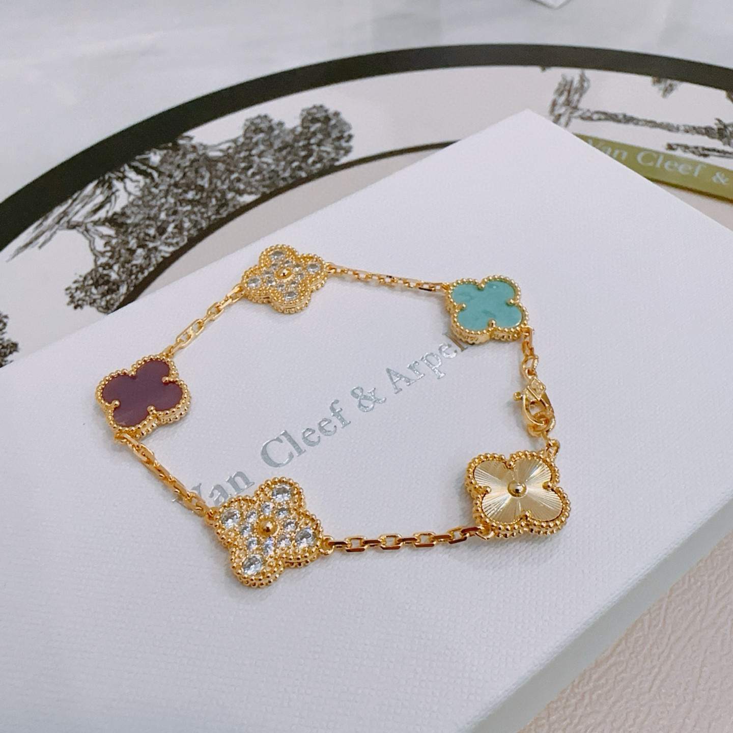 Van Cleef Arpels Alhambra bracelet Yellow gold metal with turquoise purple rhodonite clear diamond and guilloche gold four-leaf clover motifs 18cm
