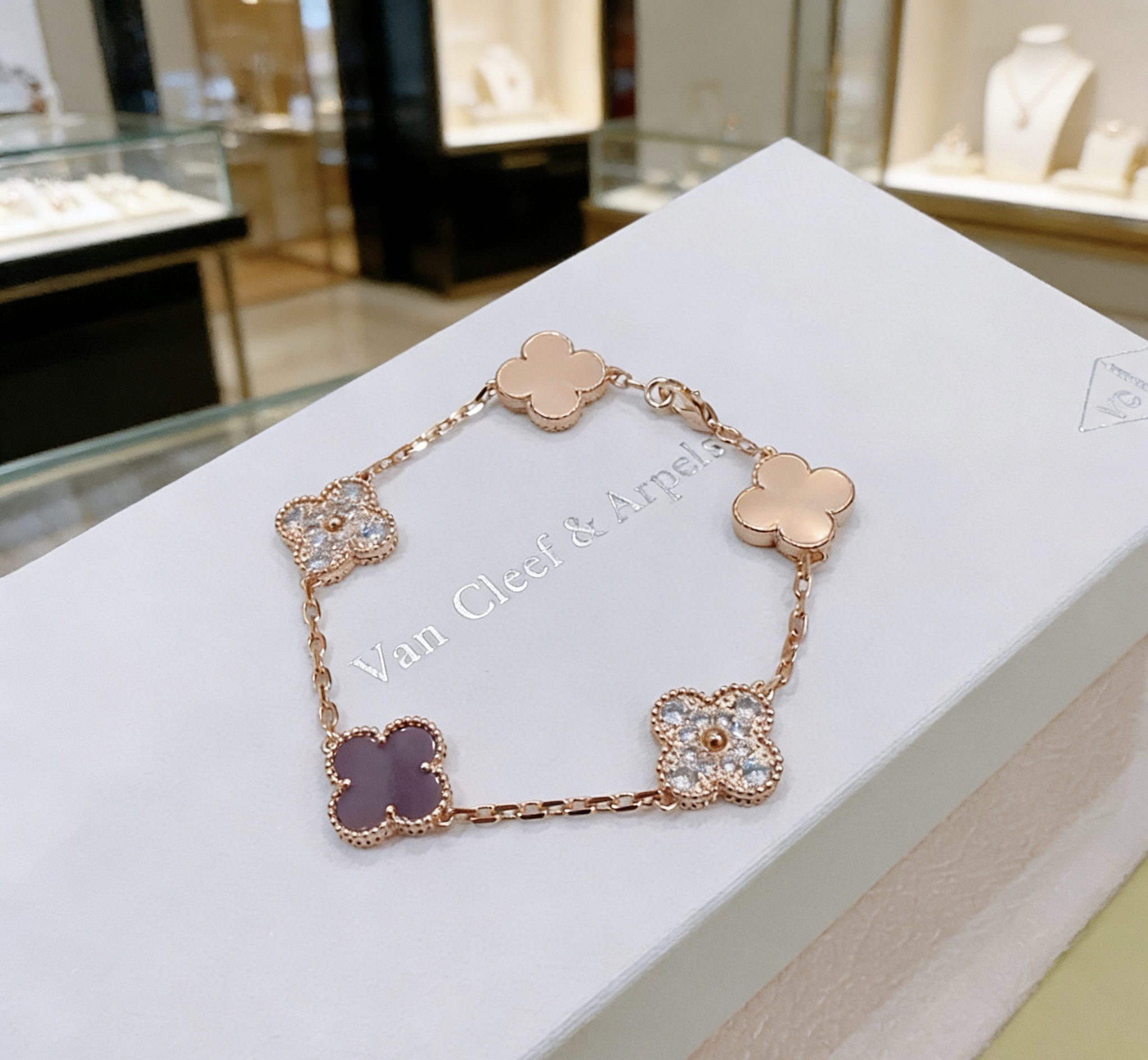 Van Cleef Arpels Alhambra bracelet Rose gold metal with clear diamond accents and dark purple stone clover motifs 19cm