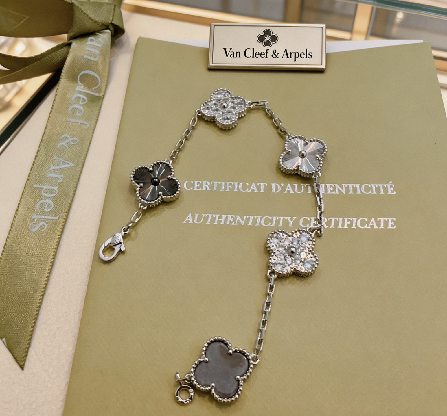 Van Cleef Arpels Alhambra bracelet Silver-toned metal with clear diamond-like stones dark gray stone silver guilloche metal and dark gray clover inlays 19cm