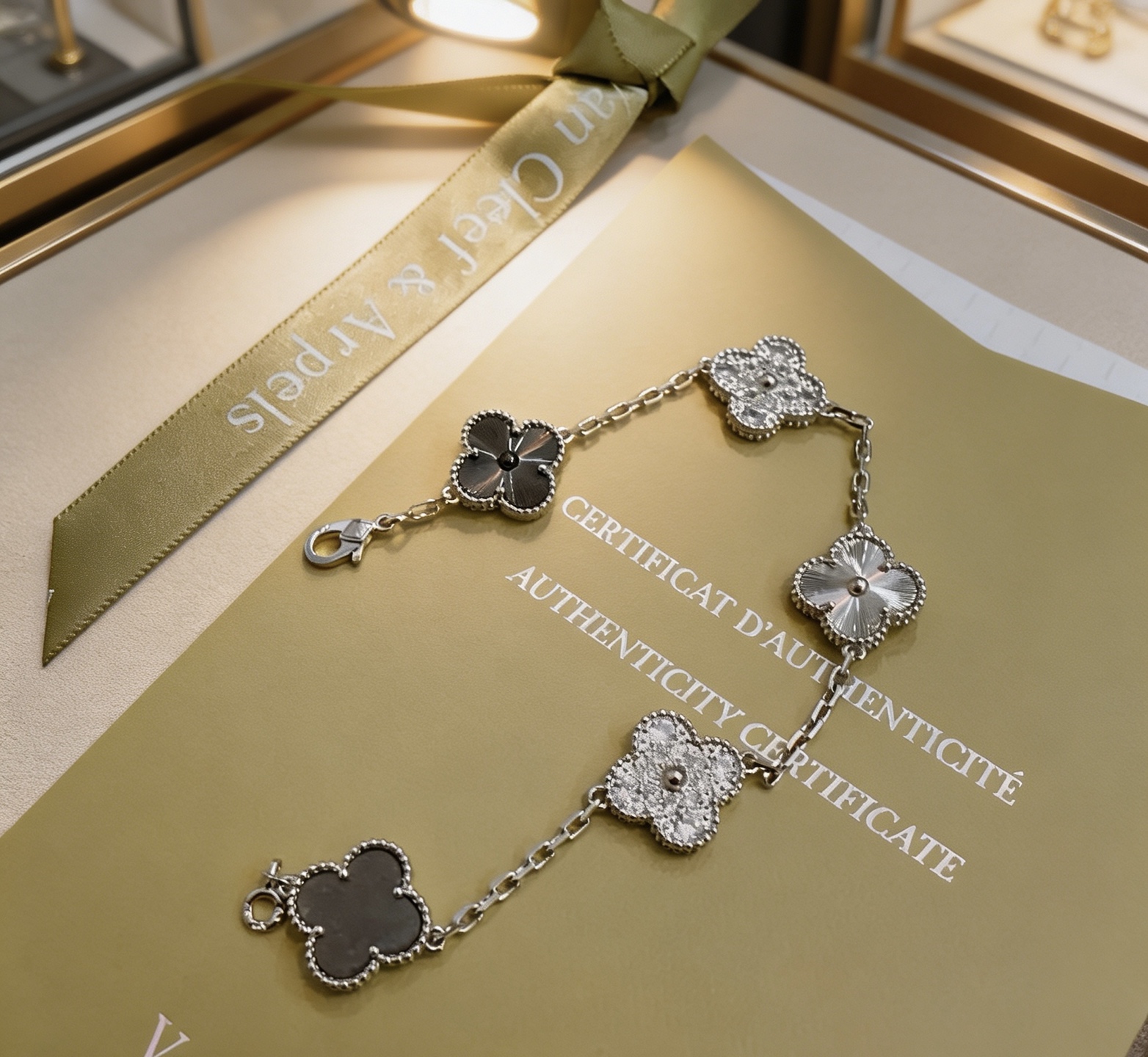 Van Cleef Arpels Alhambra bracelet Silver-toned metal with clear diamond-like stones dark gray stone silver guilloche metal and dark gray clover inlays 19cm