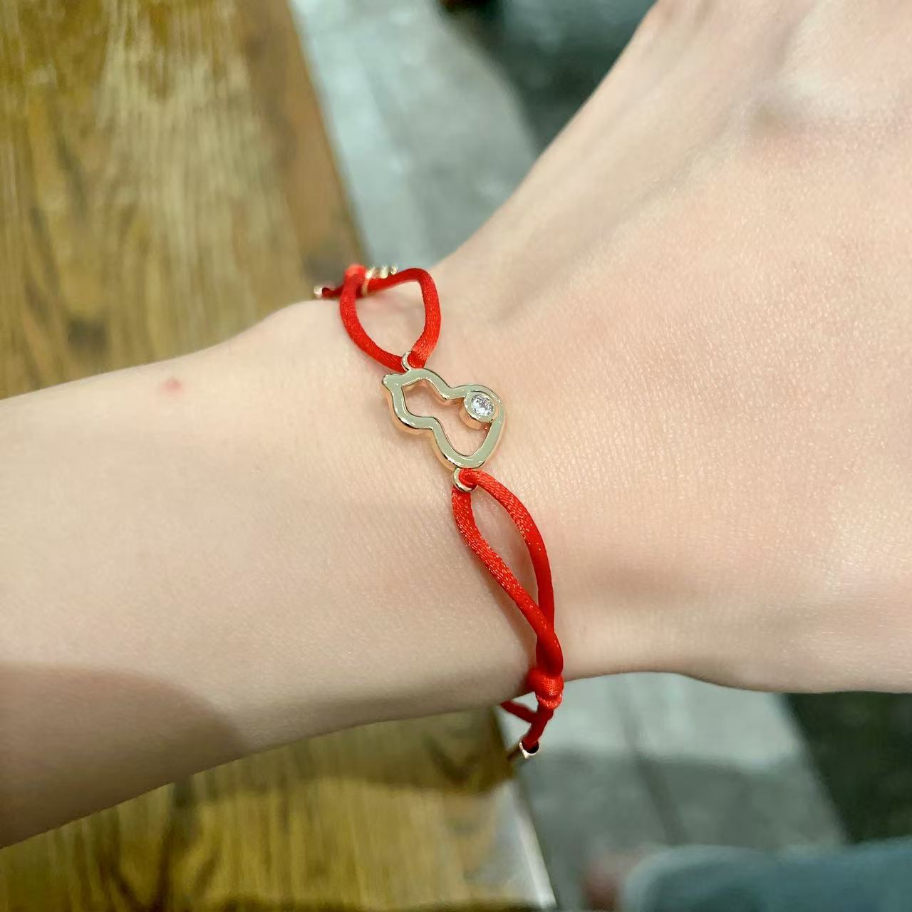 Qeelin Kirin Mini Gourd bracelet gold-toned metal clear diamond accent red cord adjustable sliding knot fits 15-19cm wrist