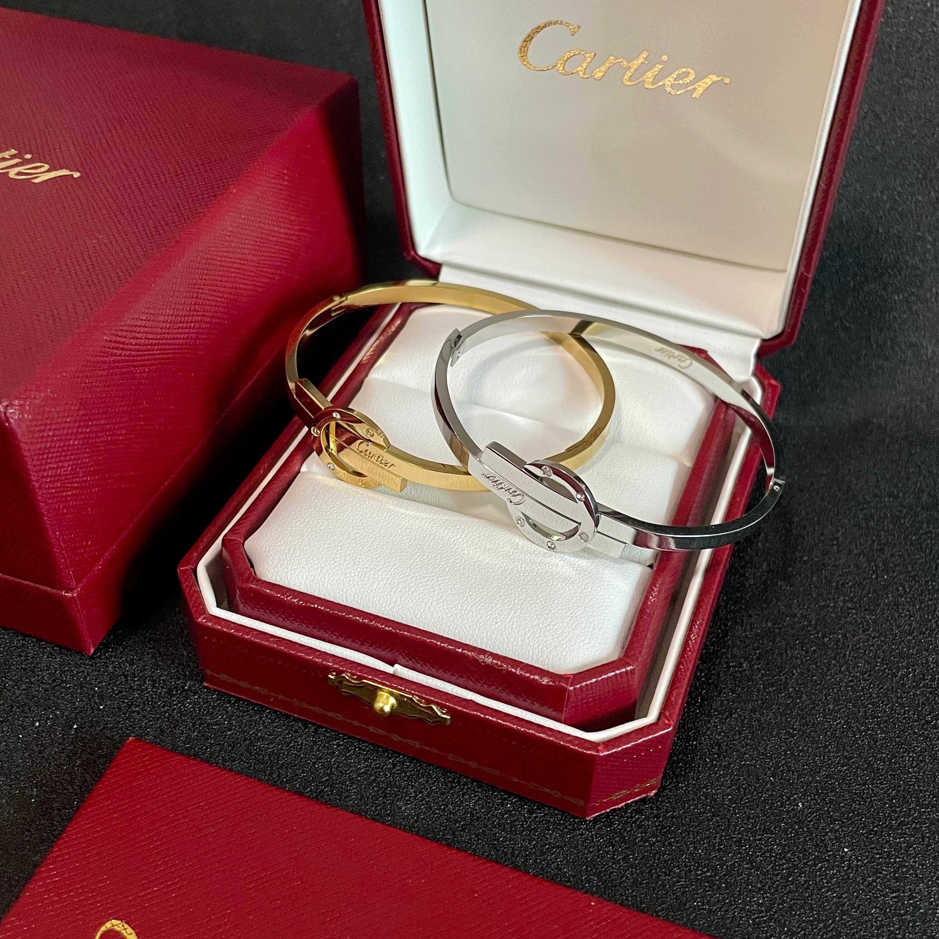 Cartier Love Interlocking Clasp Bangle bracelet Silver-toned metal with clear diamond accents 17