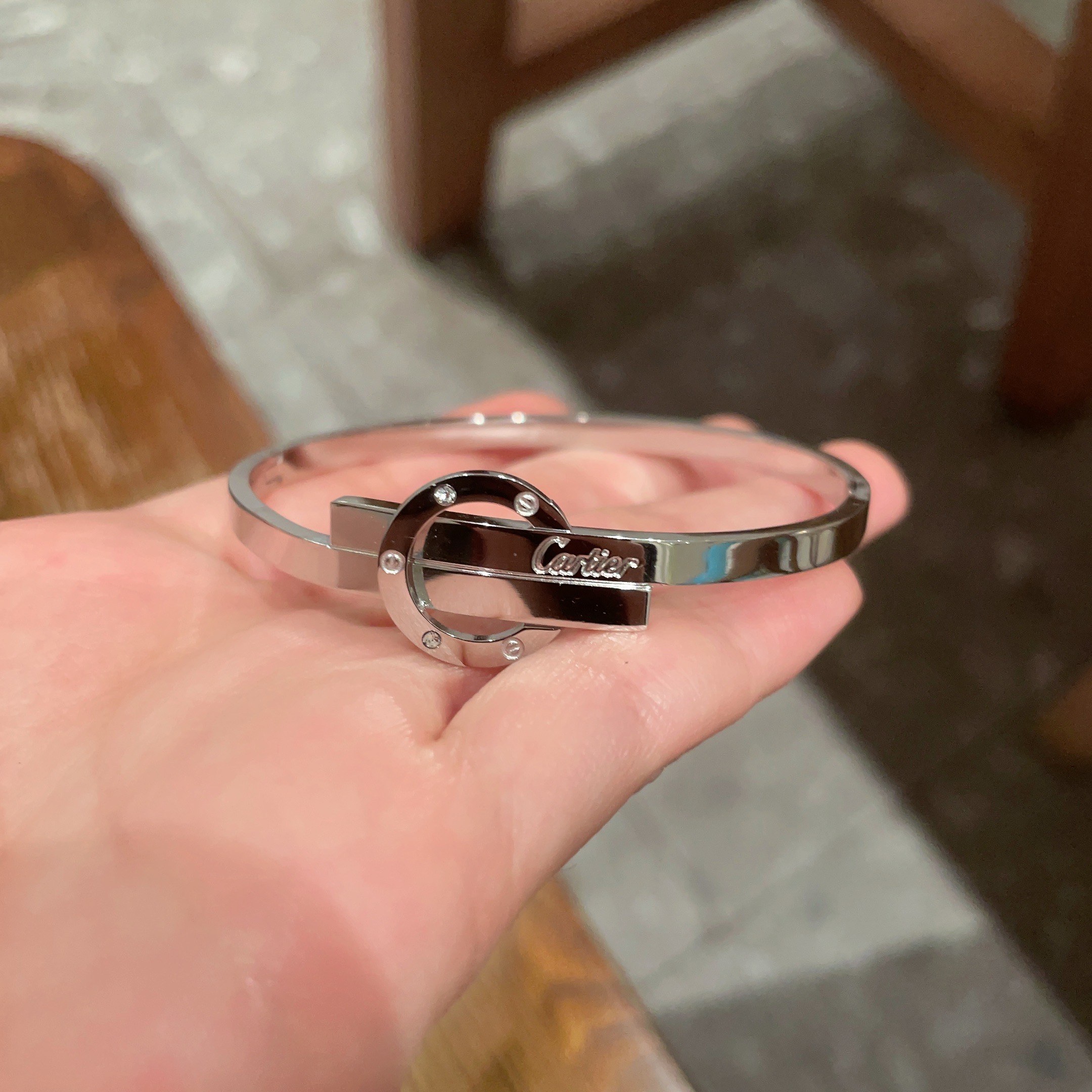 Cartier Love Interlocking Clasp Bangle bracelet Silver-toned metal with clear diamond accents 17