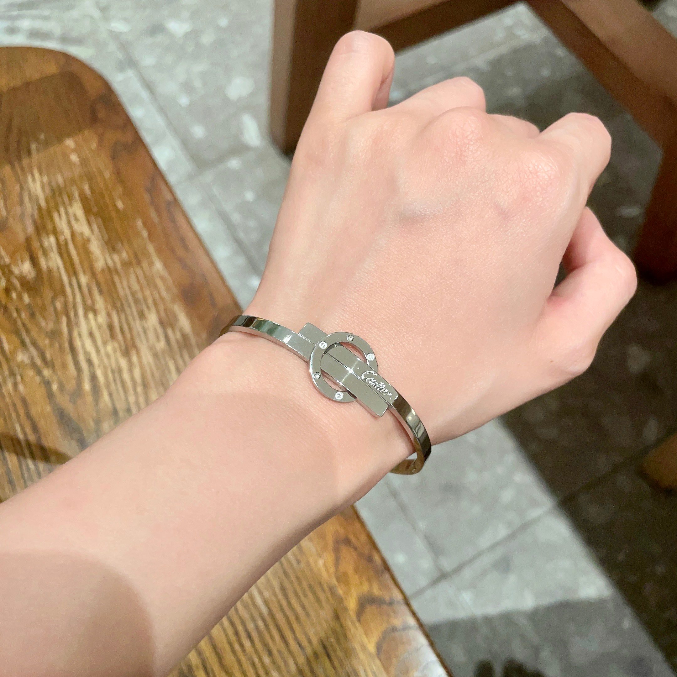 Cartier Love Interlocking Clasp Bangle bracelet Silver-toned metal with clear diamond accents 17
