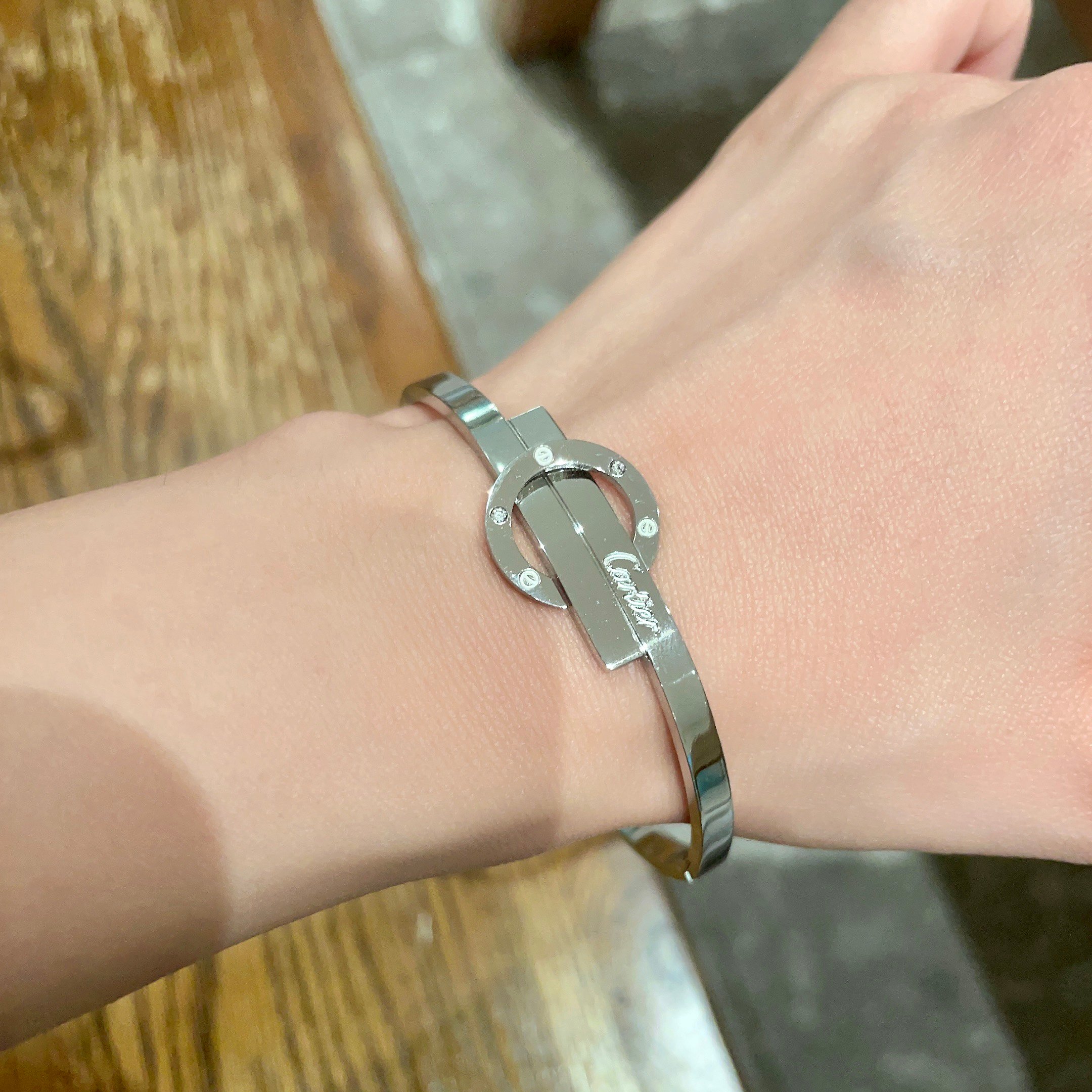 Cartier Love Interlocking Clasp Bangle bracelet Silver-toned metal with clear diamond accents 17