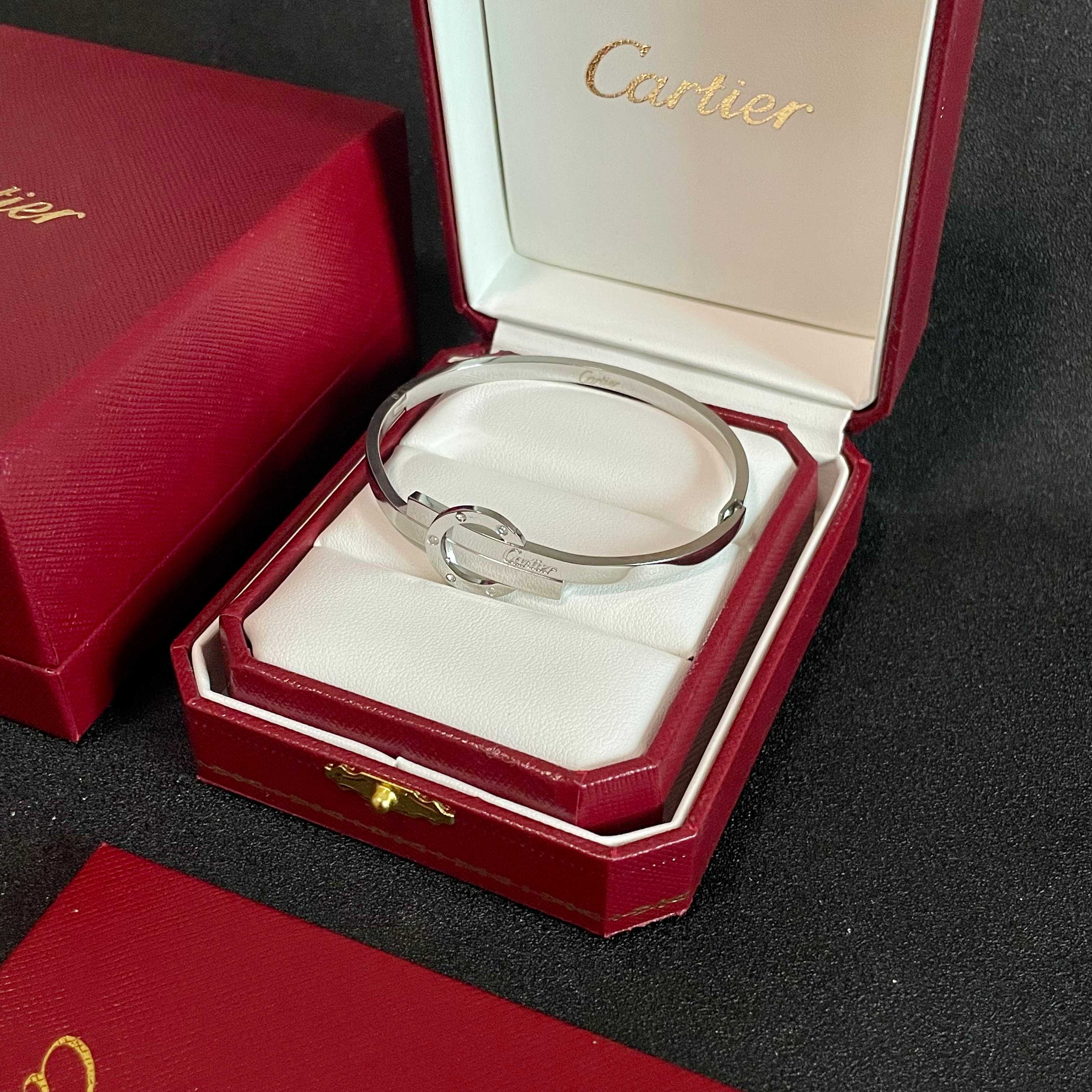 Cartier Love Interlocking Clasp Bangle bracelet Silver-toned metal with clear diamond accents 17
