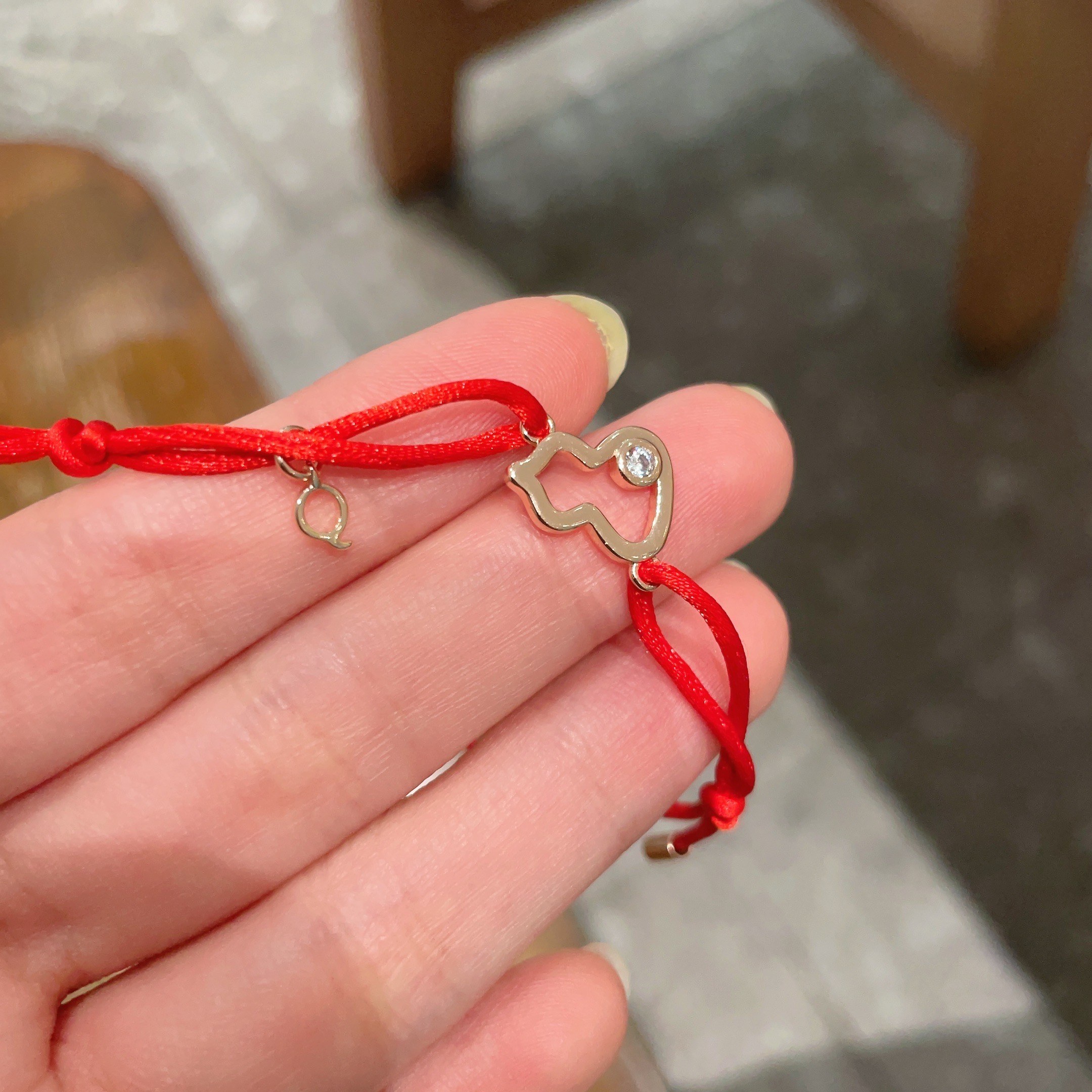Qeelin Kirin Mini Gourd bracelet gold-toned metal clear diamond accent red cord adjustable sliding knot fits 15-19cm wrist