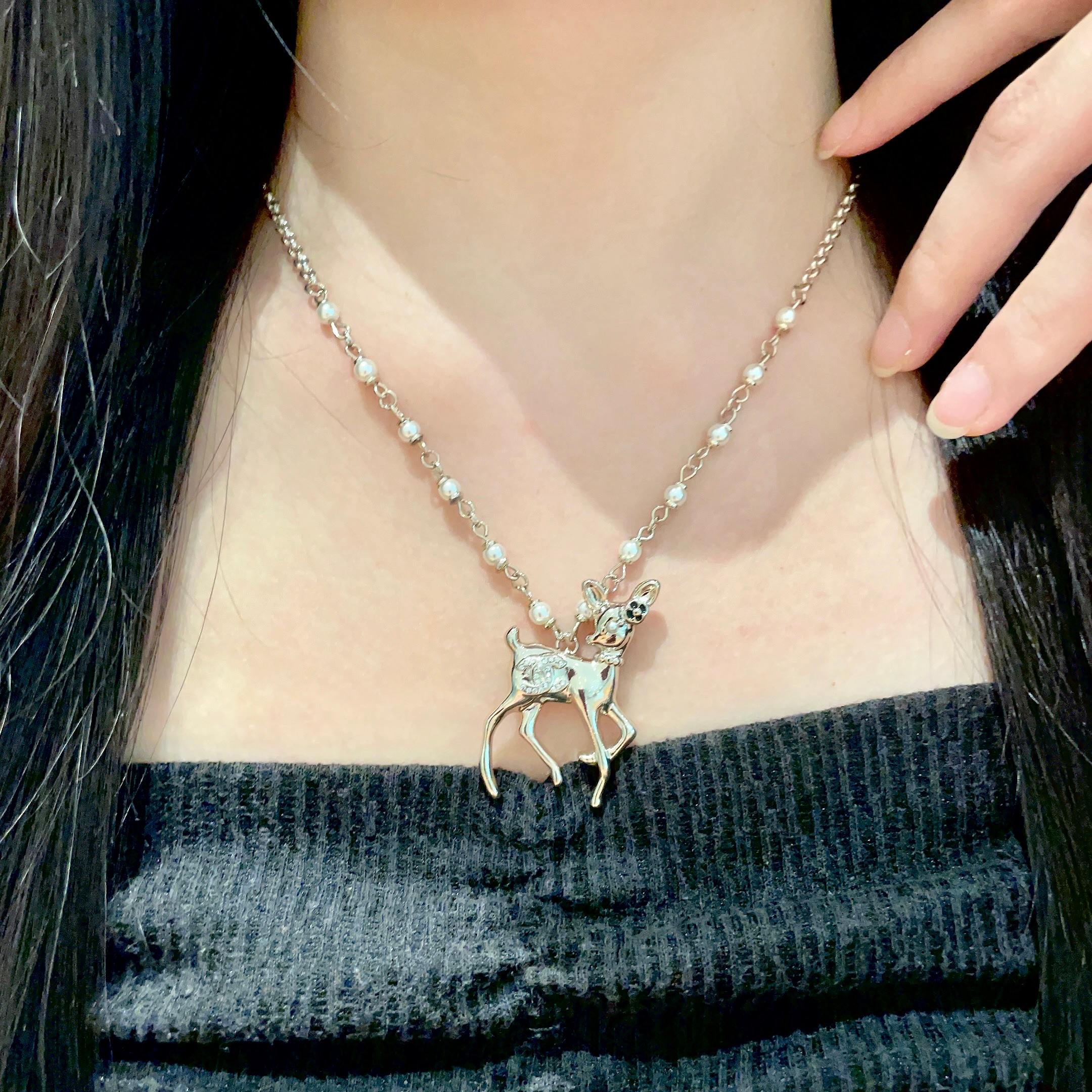Chanel CC Logo Bambi Deer Pearl Pendant necklace Light gold-tone metal white faux pearls clear crystals black enamel accents 42cm