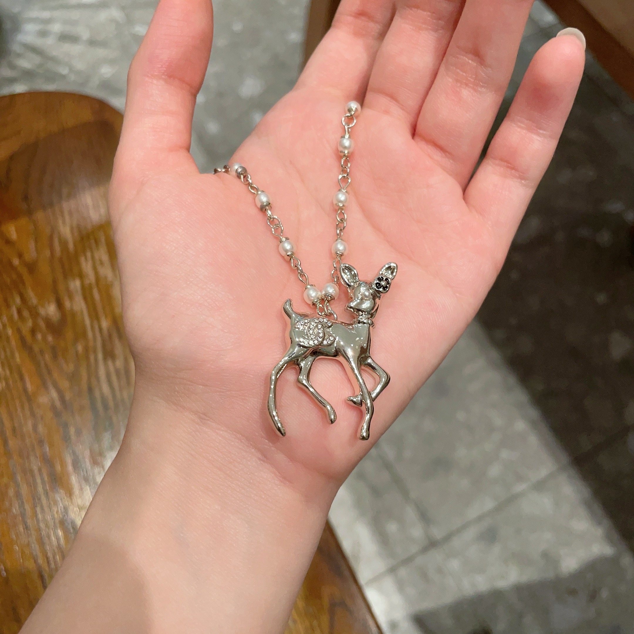 Chanel CC Logo Bambi Deer Pearl Pendant necklace Light gold-tone metal white faux pearls clear crystals black enamel accents 42cm