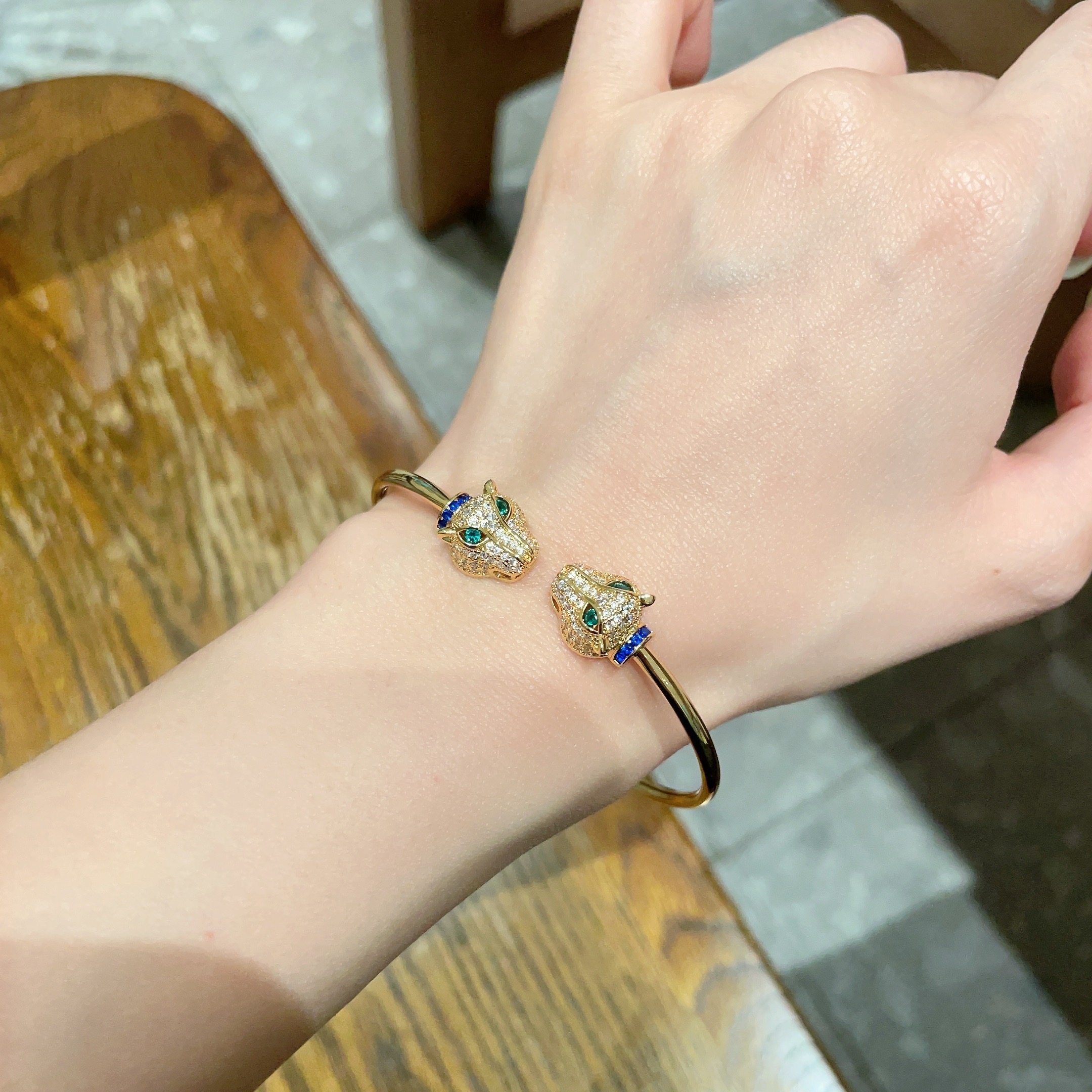 Cartier Panthere de Cartier bracelet 18k yellow gold pave clear diamonds emerald green eyes blue sapphire accents 17