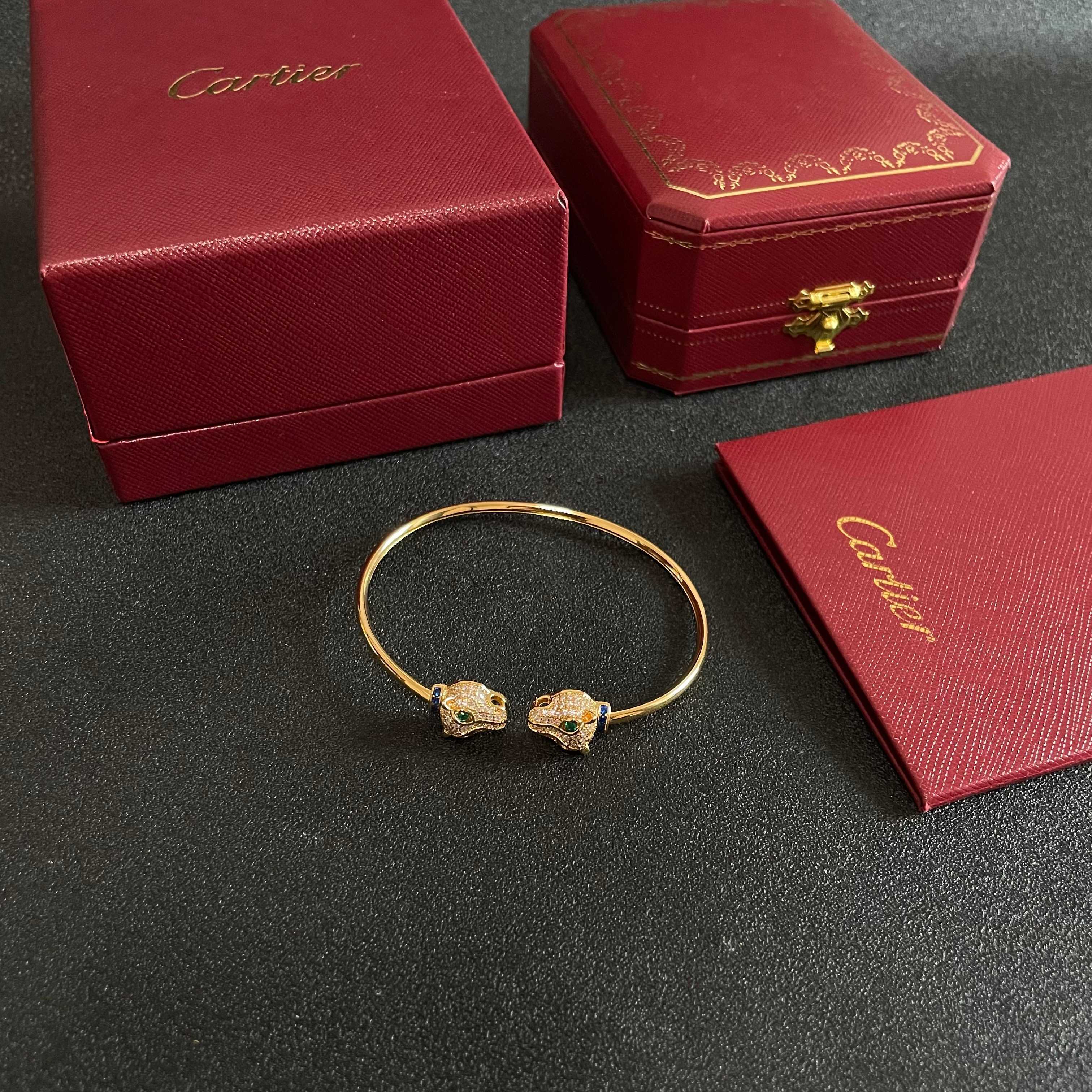 Cartier Panthere de Cartier bracelet 18k yellow gold pave clear diamonds emerald green eyes blue sapphire accents 17